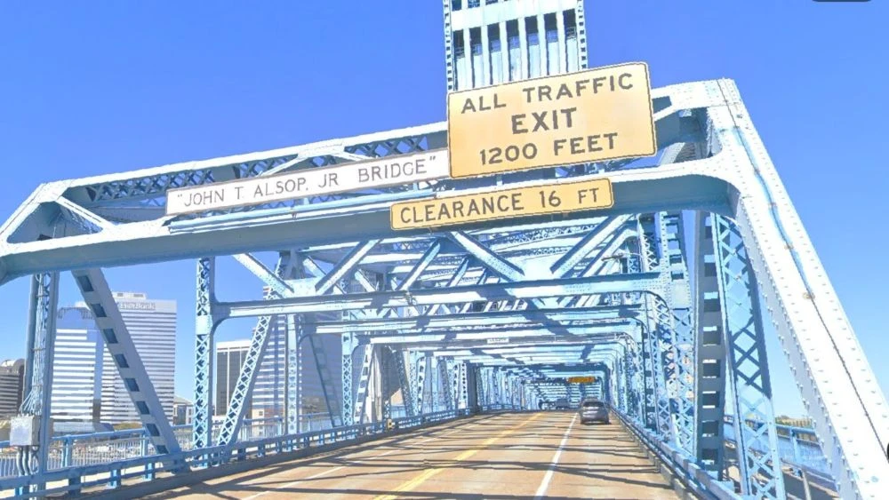 A sign shows the official name of the Main Street Bridge.