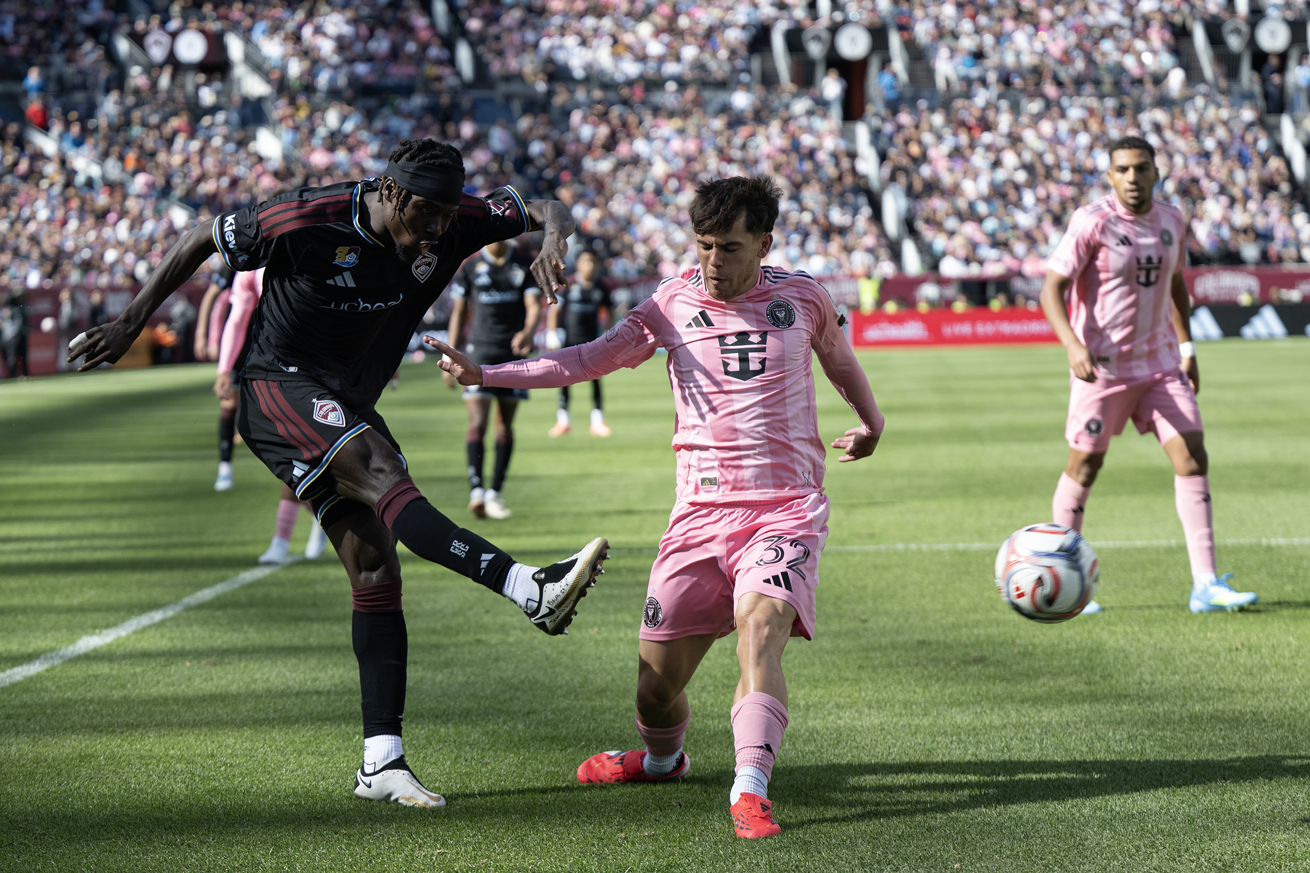 Forward Georgi Minoungou (93) of the Colorado Rapids boots it...