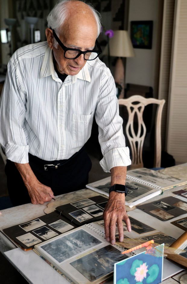 Holocaust survivor Max Heppner, 92, reviews family photos from Berlin, Germany, at his home on Tuesday, April 21, 2026. Heppner is traveling to Germany for a ceremony to lay memorial stones at his family's former residences. (Mike Stocker/South Florida Sun Sentinel)