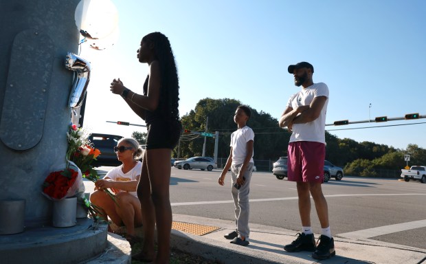 Family of Ronald Wilson gather to create a makeshift memorial at the intersection of Prospect Road and Northwest 31st Avenue in Tamarac on Monday, March 23, 2026. Wilson, an uninvolved bystander, died in a crash with a Broward Sheriff's Office deputy that occurred during a pursuit of an aggravated battery suspect driving a stolen car, court records say. (Carline Jean/South Florida Sun Sentinel)