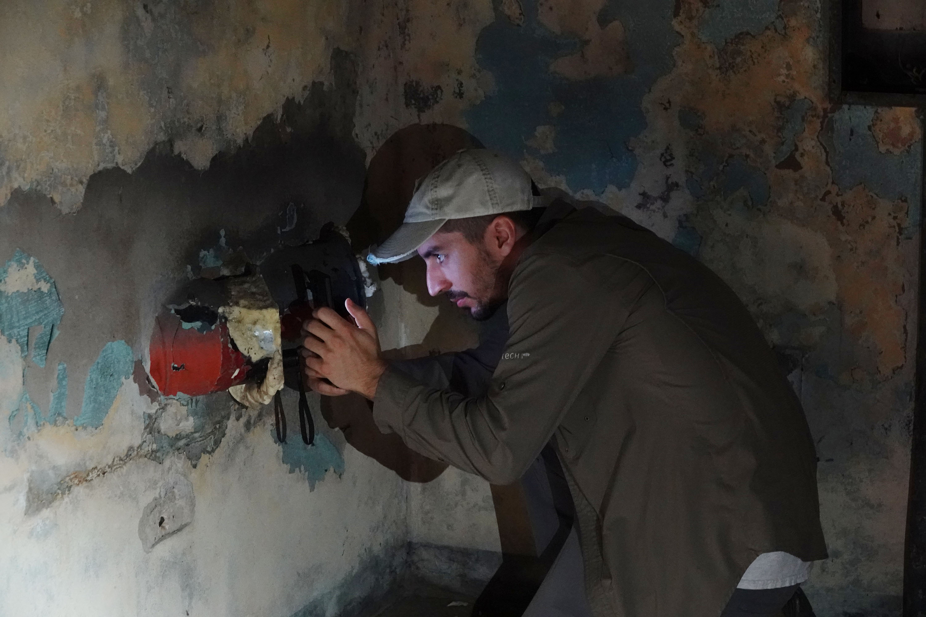 A.J. Sanjar looks into a pipe inside an abandoned Cold...