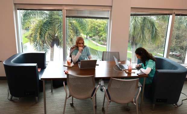 College of Optometry students Shaheed Aisheh and Lara Chouljian, both of Davie, study at the Alvin Sherman Library at Nova Southeastern University on Tuesday, April 7, 2026. The library serves as a community hub for those looking for quiet time and relaxation. (Carline Jean/South Florida Sun Sentinel)