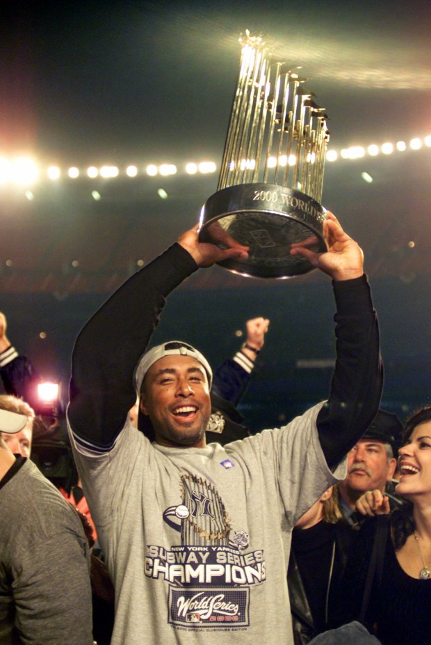 New York Yankees' Bernie Williams hold up his team's 2000World Series trophy after defeating the New York Mets 4-2 in Game 5 of the World Series early Friday, Oct. 27, 2000, at New York's Shea Stadium. (AP Photo/Amy Sancetta)