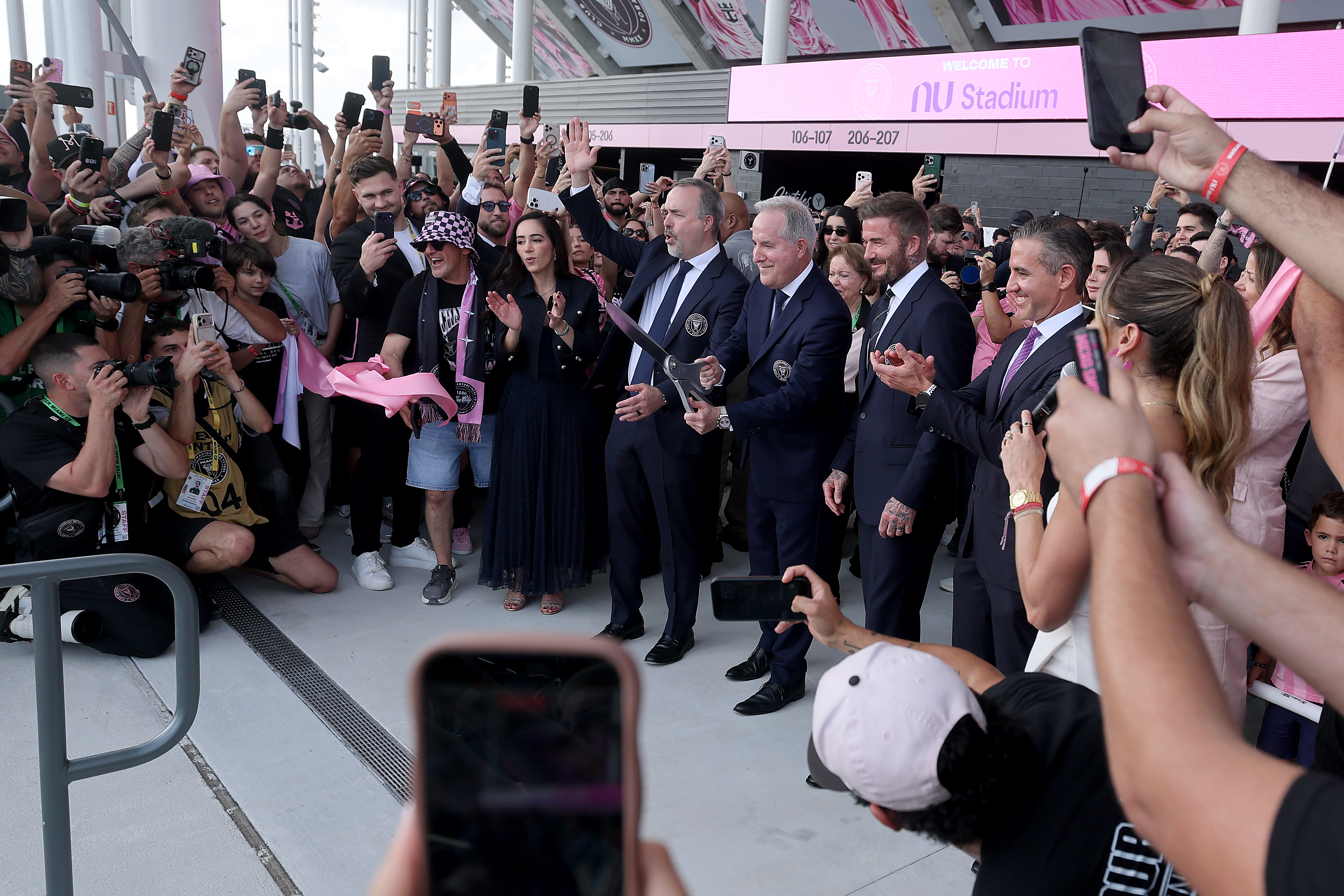 Jose Mas, Jorge Mas, and David Beckham cut the ribbon...