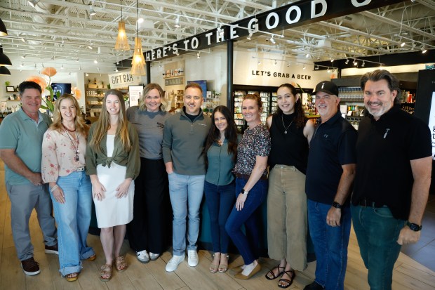 The Good Pour husband-and-wife founders Ray and Giuliana Horal, center, with their team at the wine and spirits retail shop in Winter Park on Thursday, April 16, 2026. (Rich Pope/Orlando Sentinel)