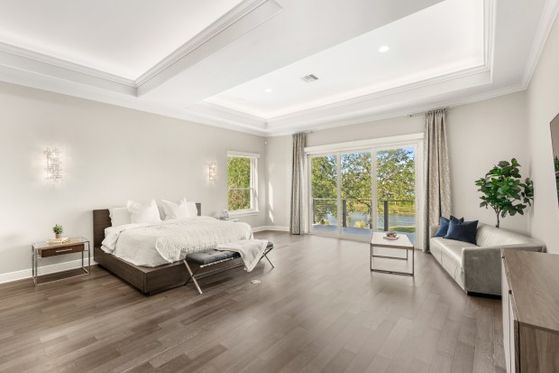 The home features two full bedroom suites on the main level, ideal for multi-generational living, guests, or options for office space. (Photo courtesy of Pozek Group)