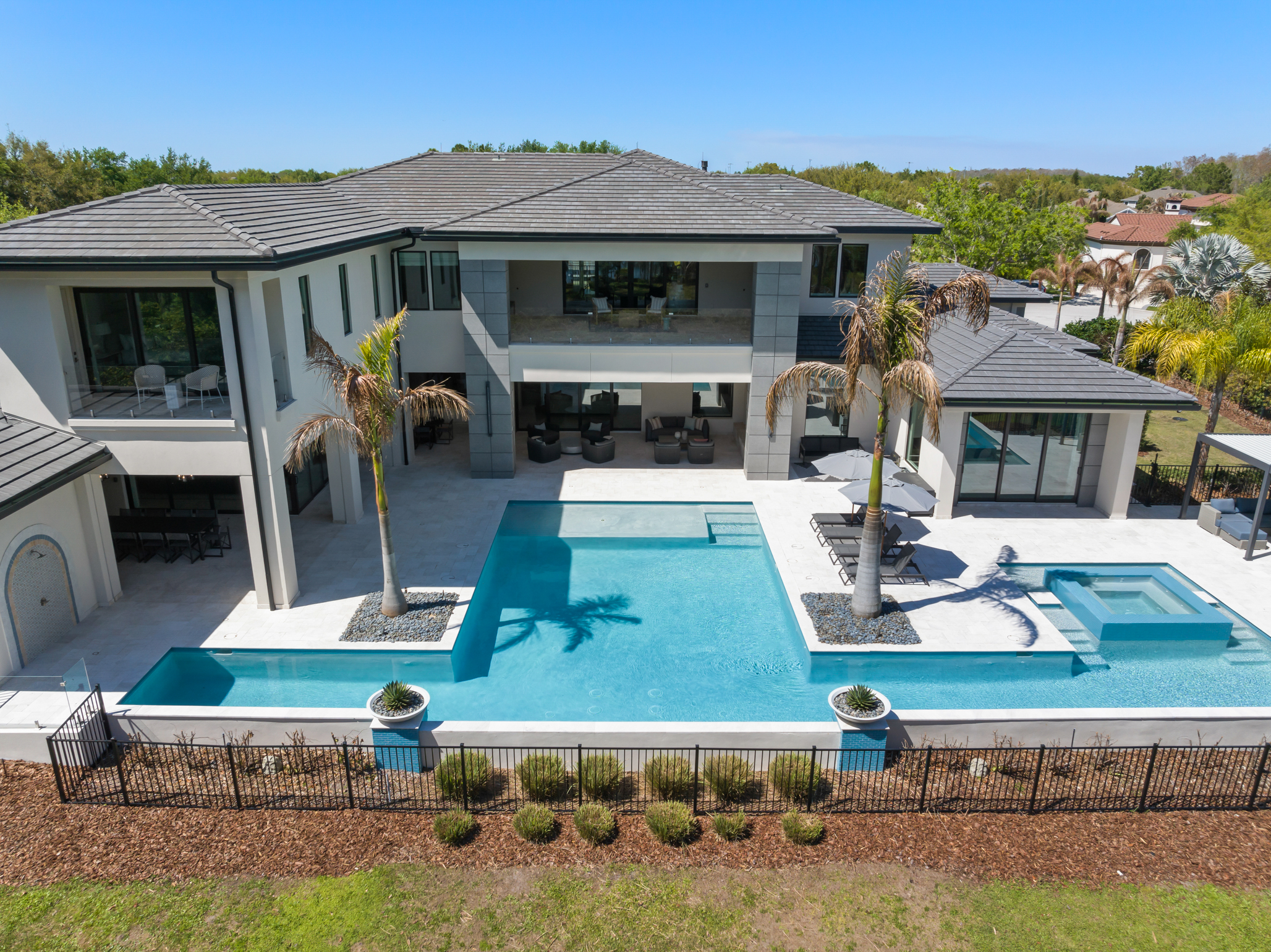 The resort-style pool has areas to relax and sun, as...