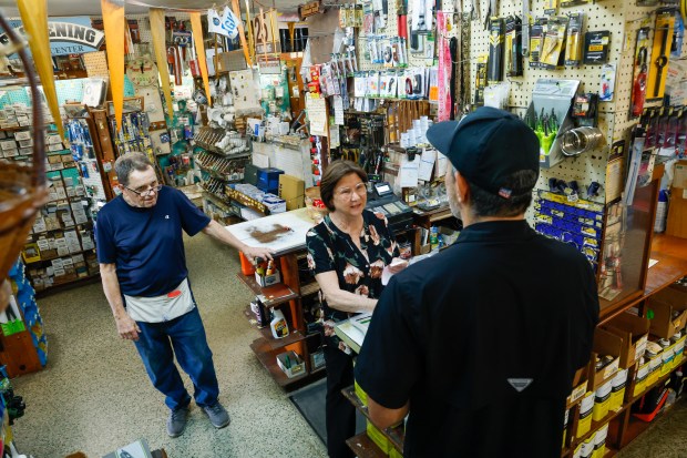 Belinda and Larry Finley, longtime owners of J&L Hardware in Orlando, talk with customer Mario Dias as he pays for an item. The couple are retiring and closing the shop, which has been in operation on Orange Blossom Trail since the 1970s. (Rich Pope/Orlando Sentinel)
