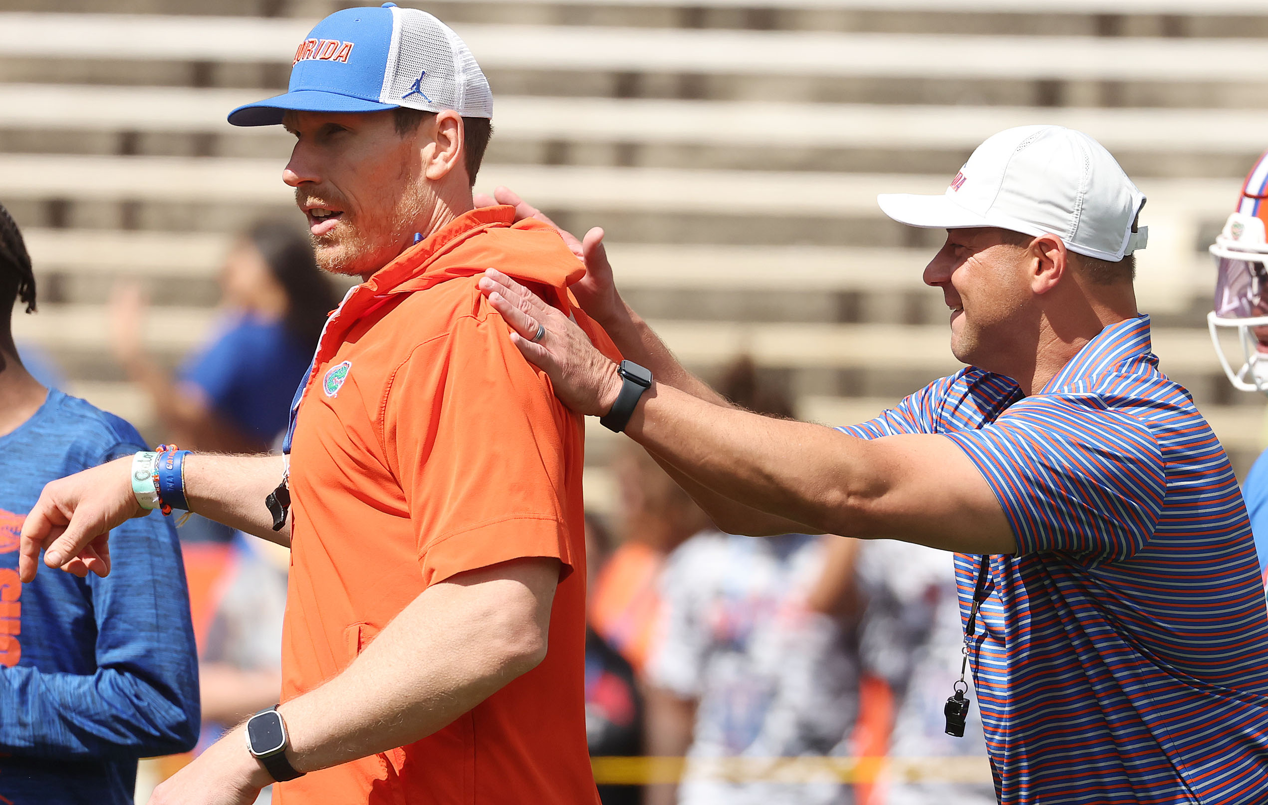University of Florida head coach Jon Sumrall (right) shares a...
