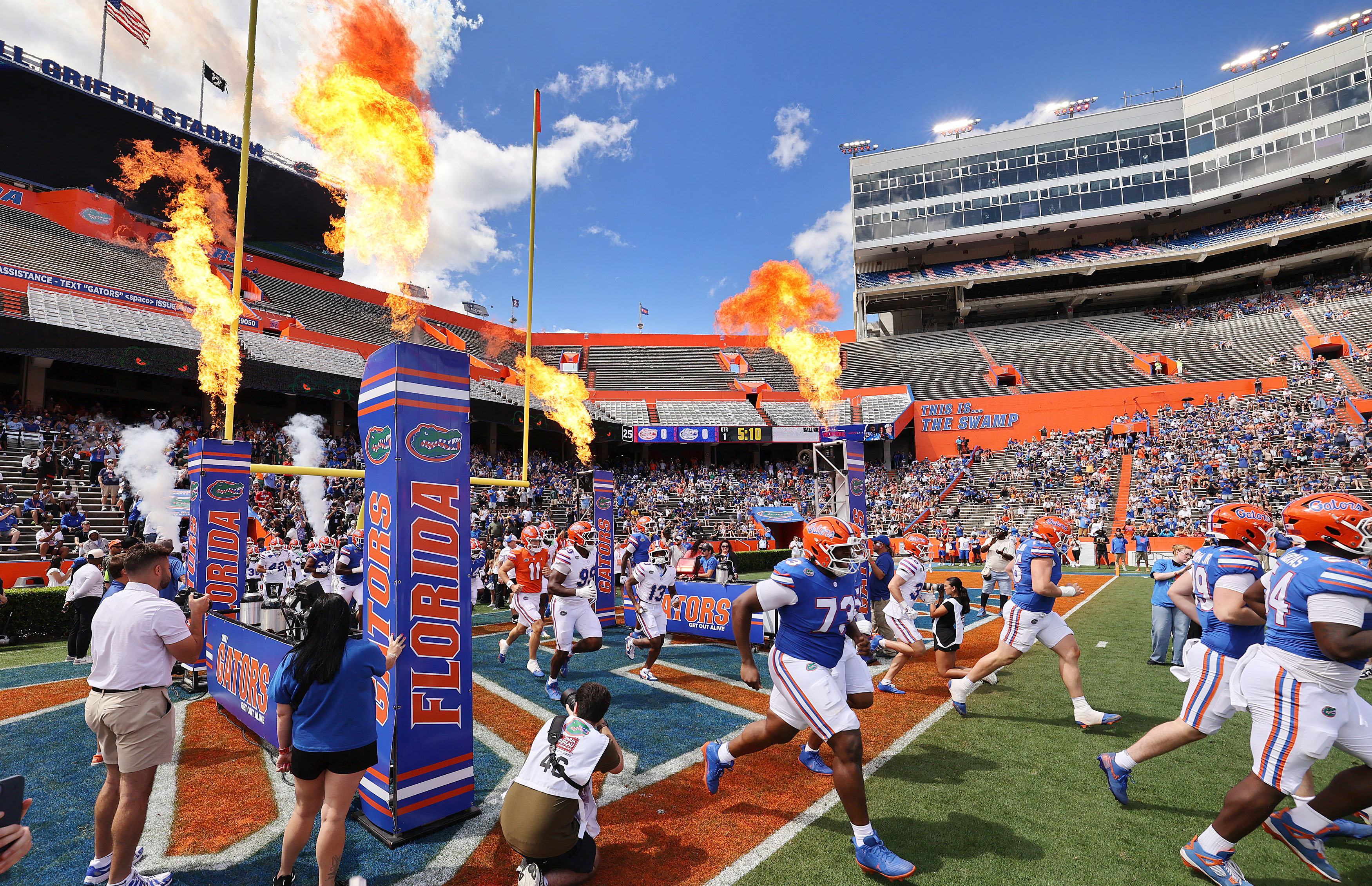 University of Florida players run onto the field for the...