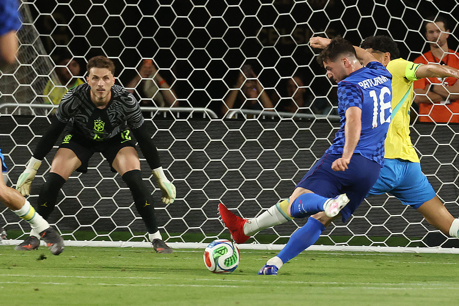 Croatia player Martin Baturina (16) kicks at goal as Brazil...