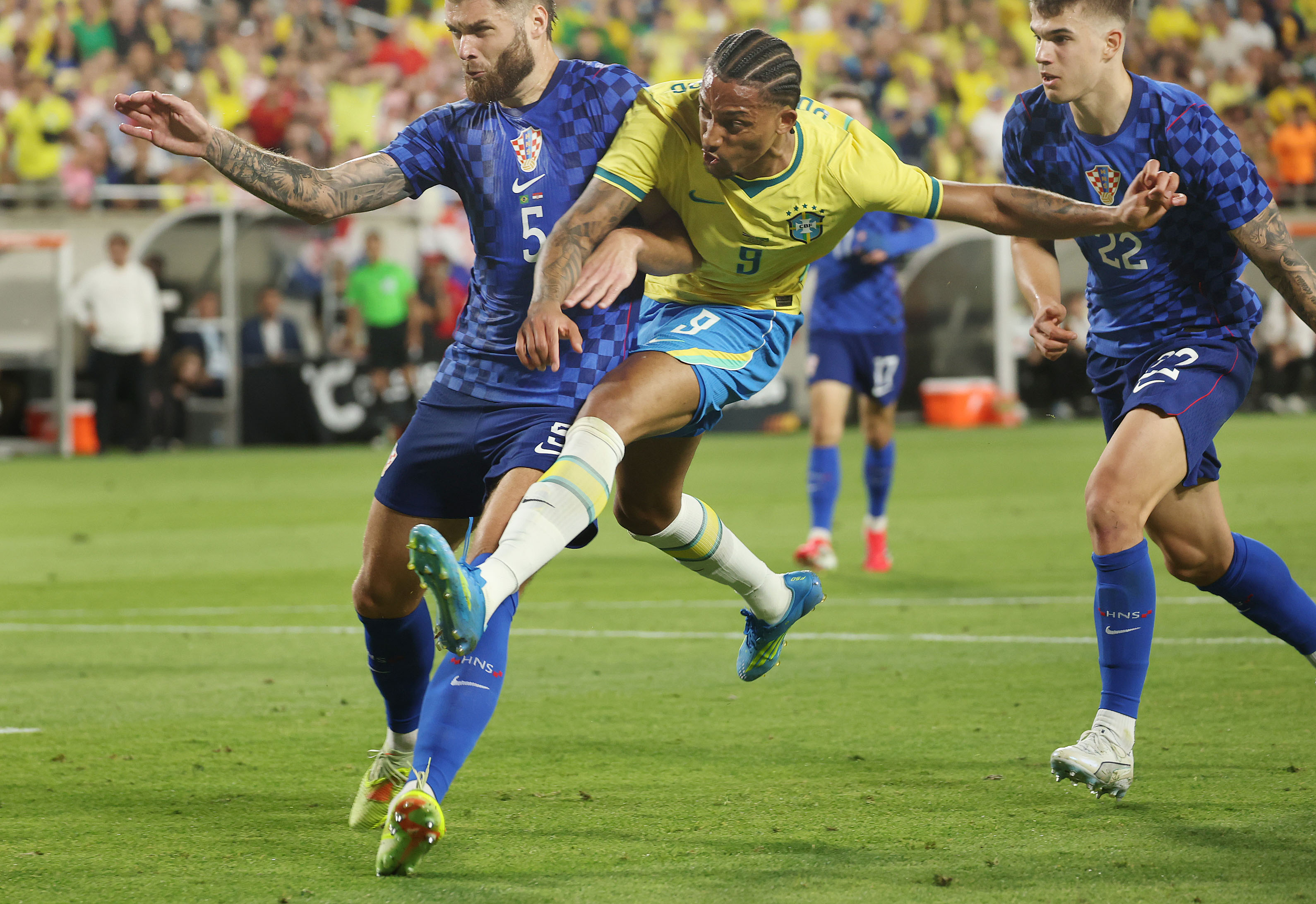 Brazil player Joao Pedro (9) kicks at goal beside Croatia...