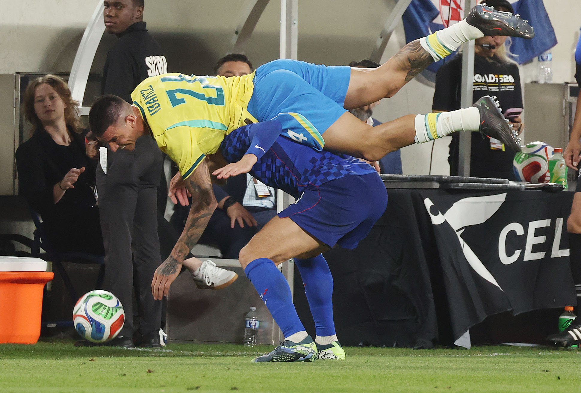 Brazil player Roger Ibanez (24) falls on top of Croatia...