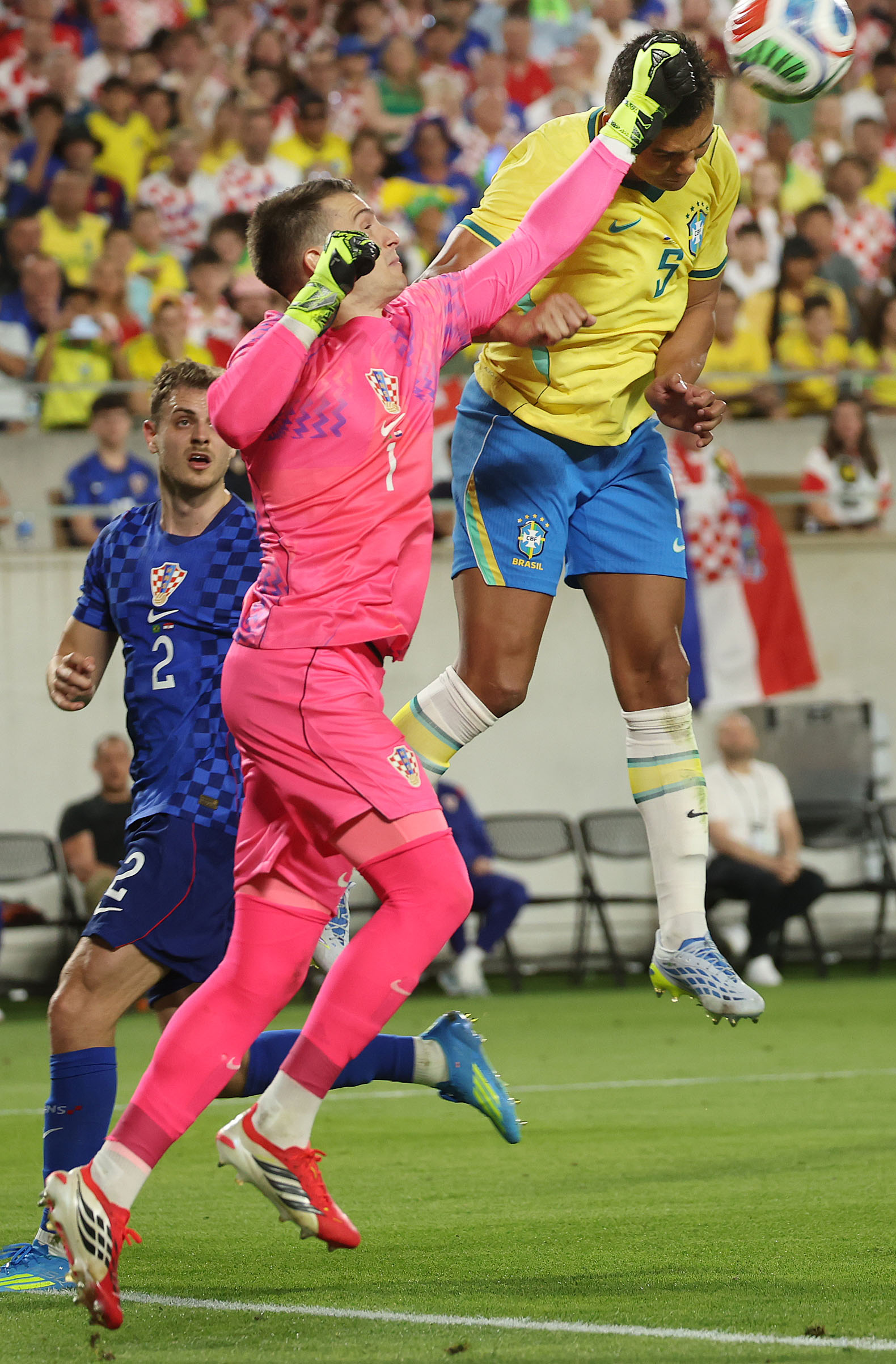 Croatia goalkeeper Dominik Likakovic (1) stops a header by Brazil...