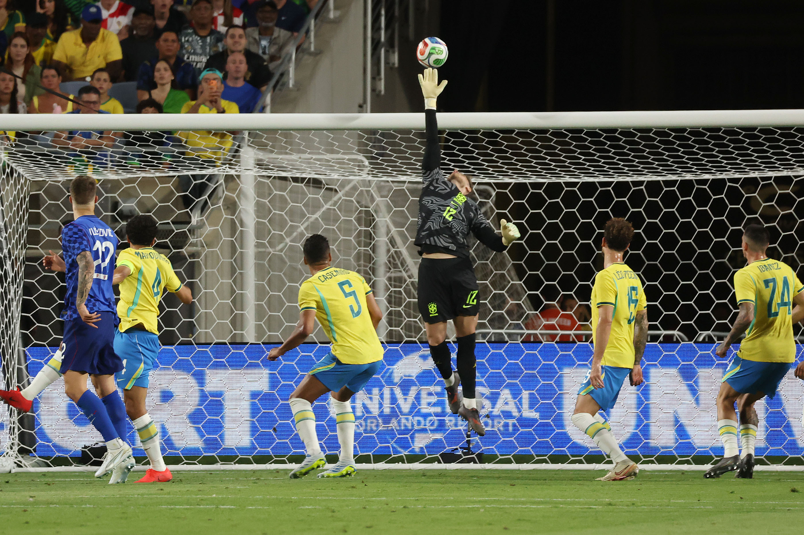 Brazil goalkeeper Bento (12) leaps to make an athletic save...