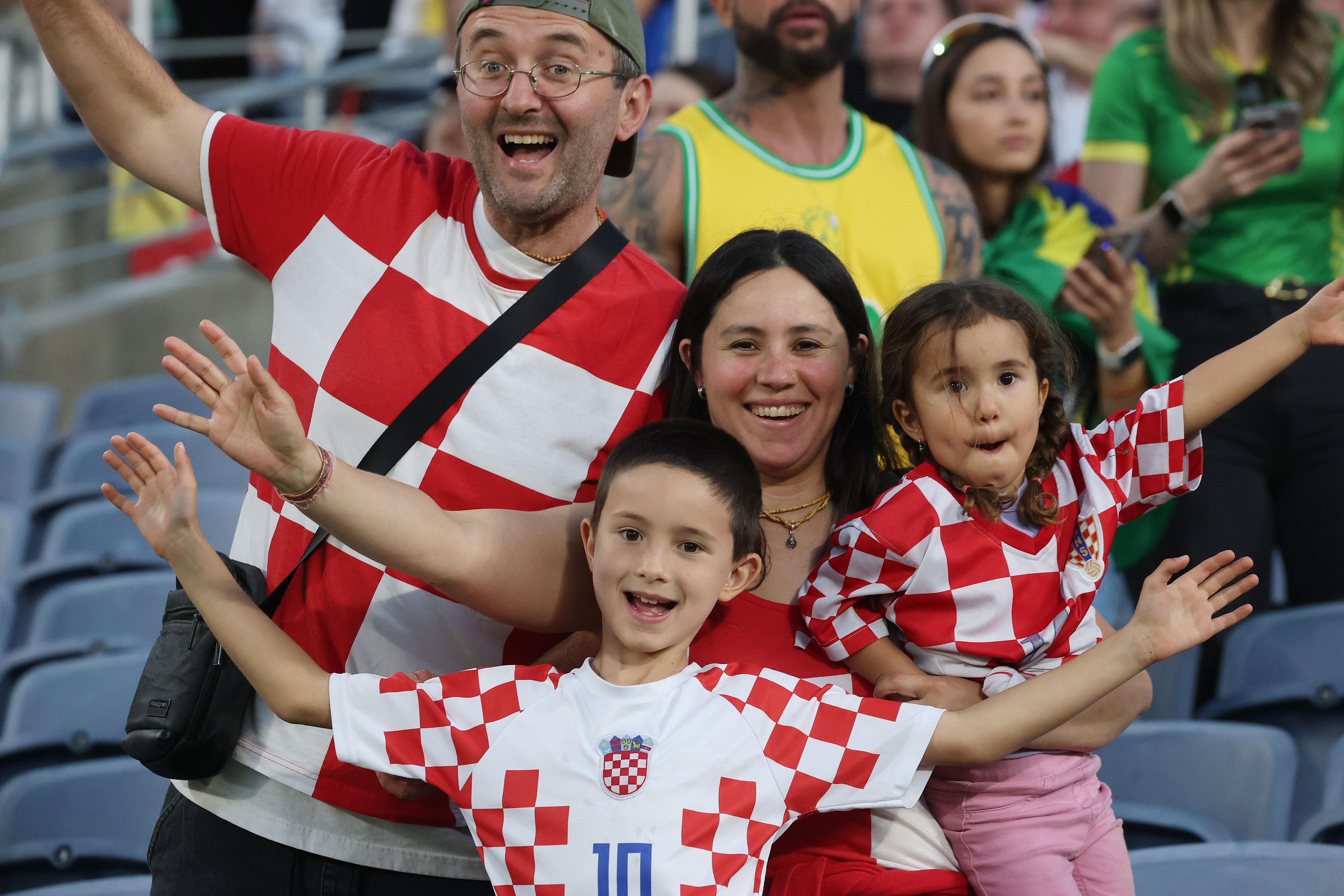 A family of Croatia fans cheers during the Brazil vs....