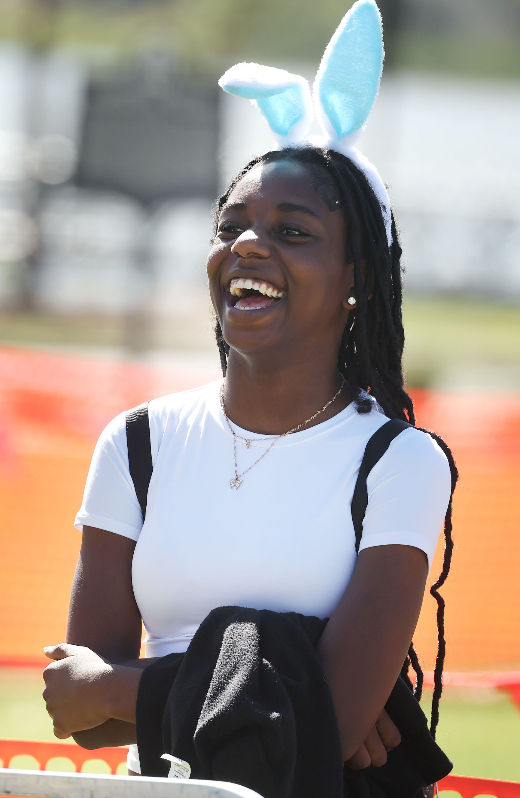 A bunny-ear wearing parent smiles during the Easter Eggstravaganza at...