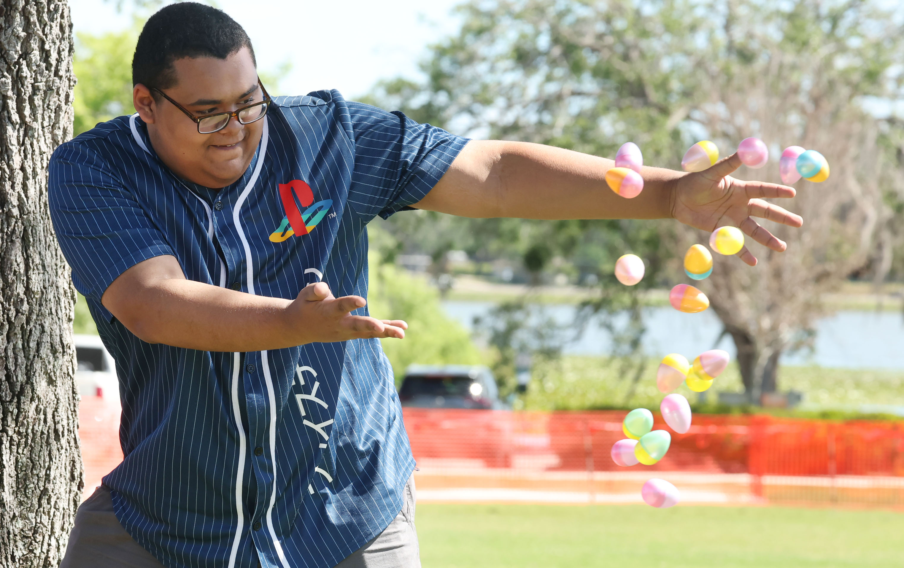 A worker throws out eggs for the Easter egg hunt...