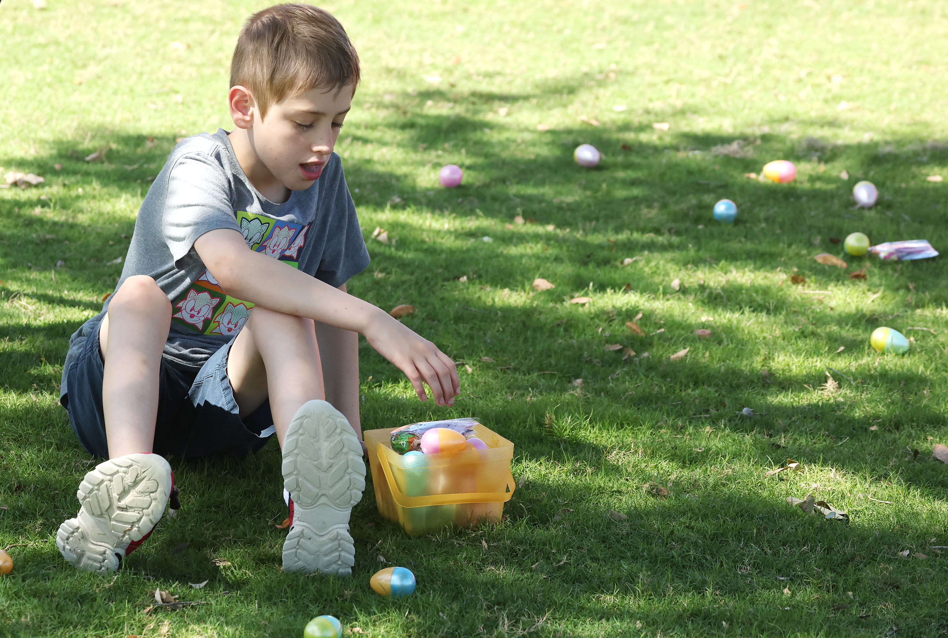 A boy gathers eggs during the special needs Easter egg...