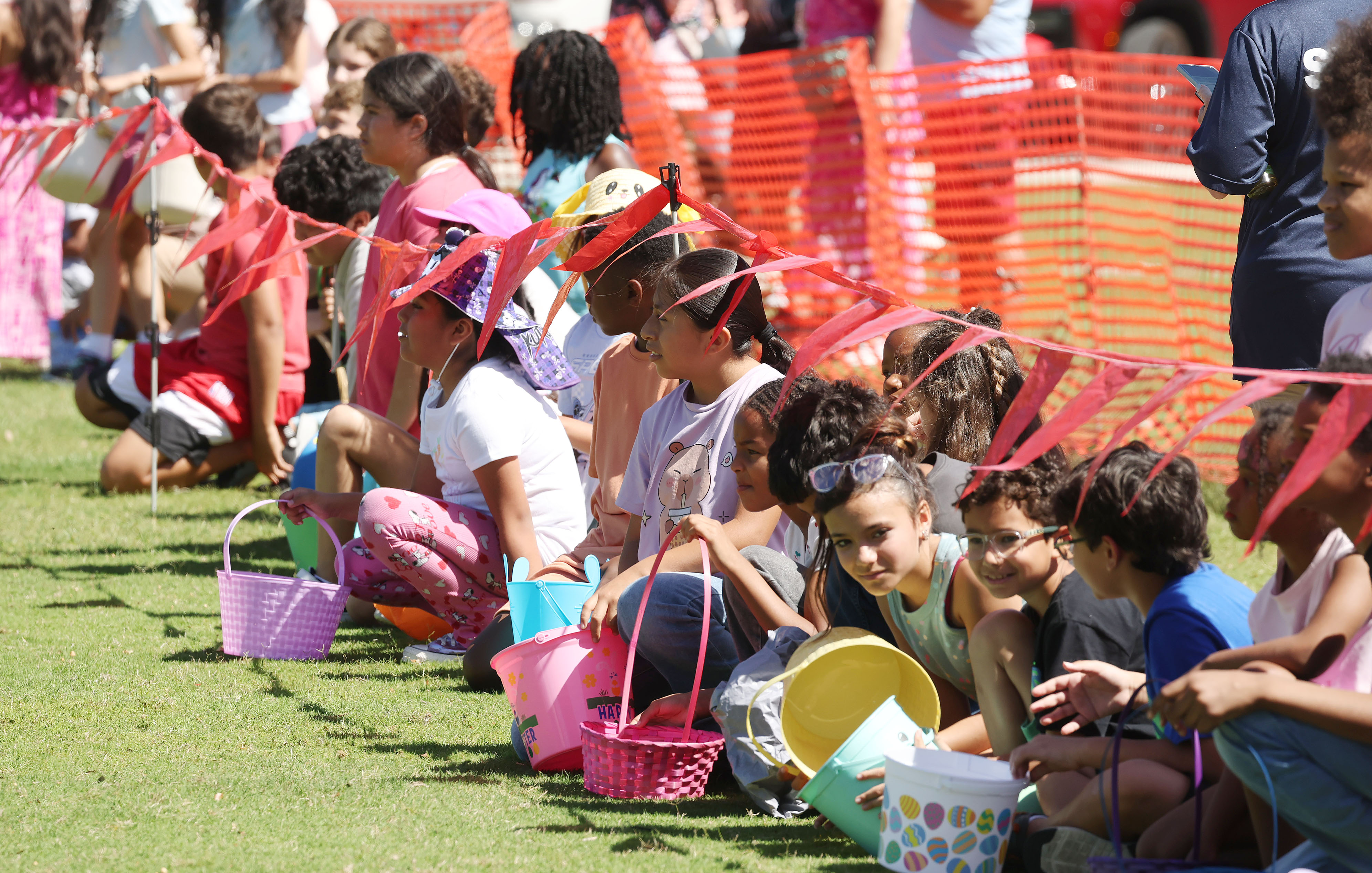 Children crowd together as they await the start of the...