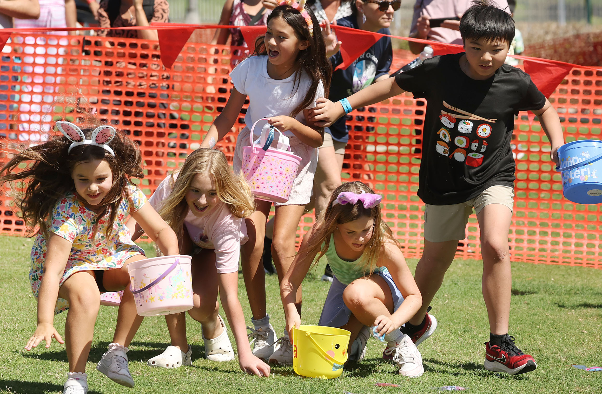 A boy at right throws a block as children scurry...