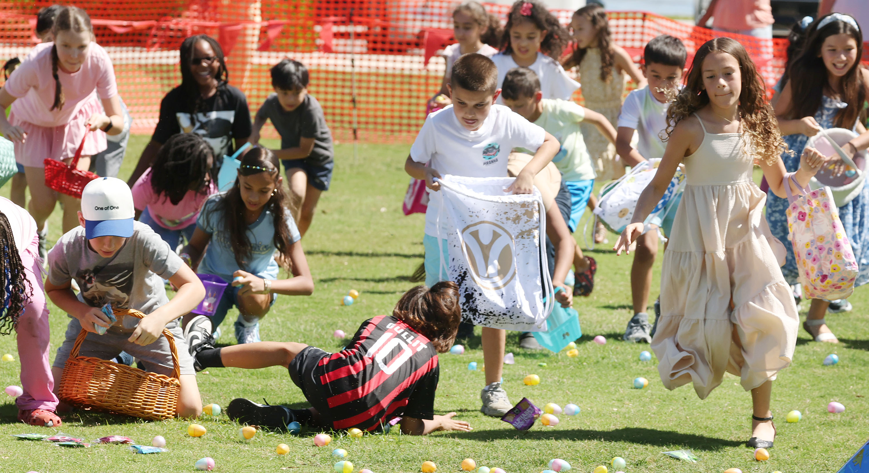 One boy takes a spill as children scurry to grab...