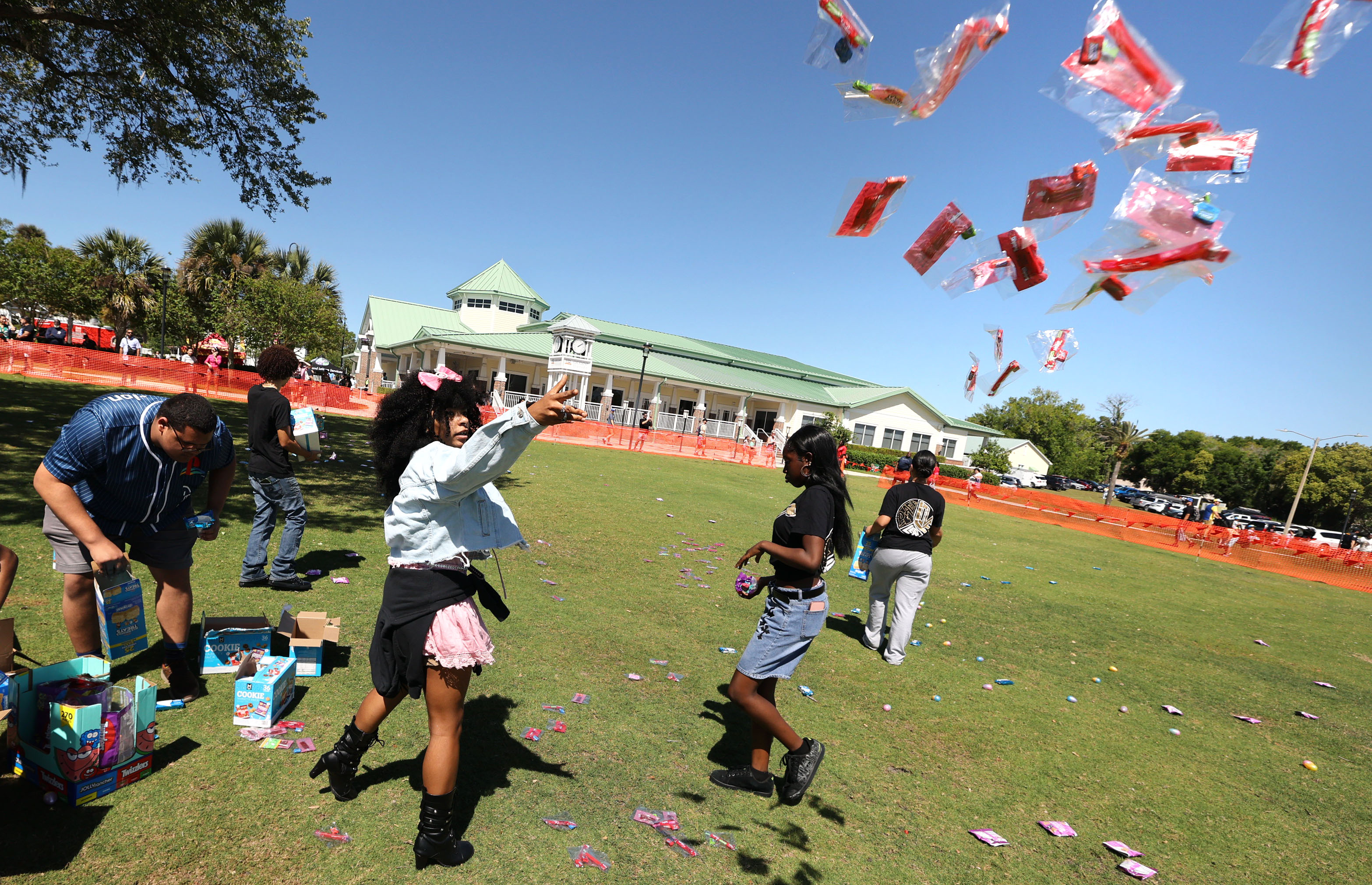 Workers fling candy and eggs onto the lawn in preparation...