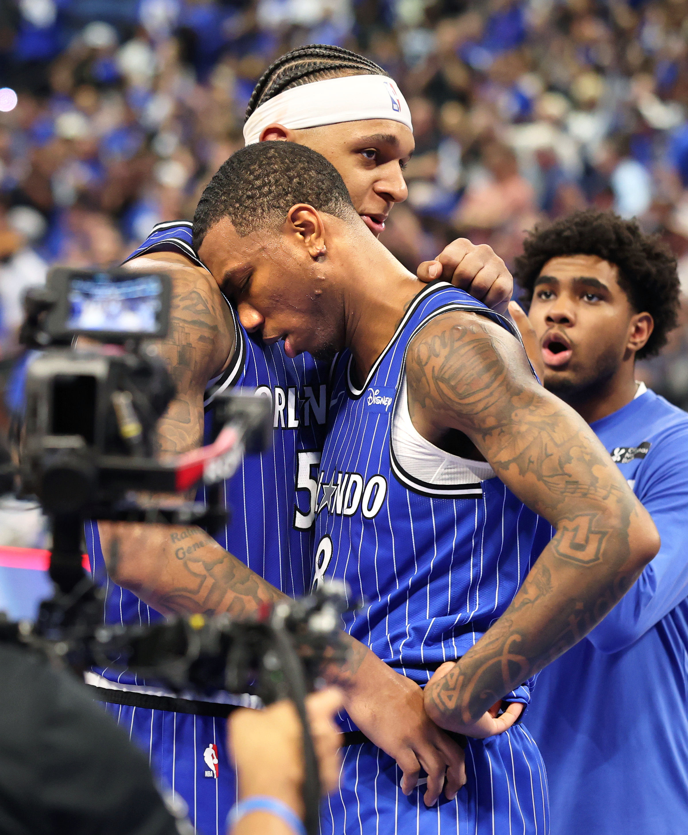 Orlando Magicâs Paolo Banchero and Jamal Cain embrace after winning...