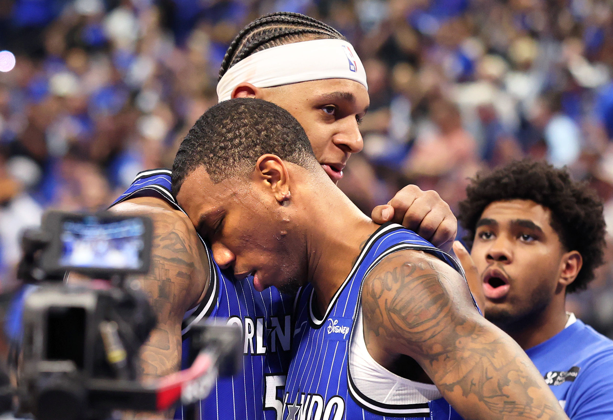 Orlando Magicâs Paolo Banchero and Jamal Cain embrace after winning...