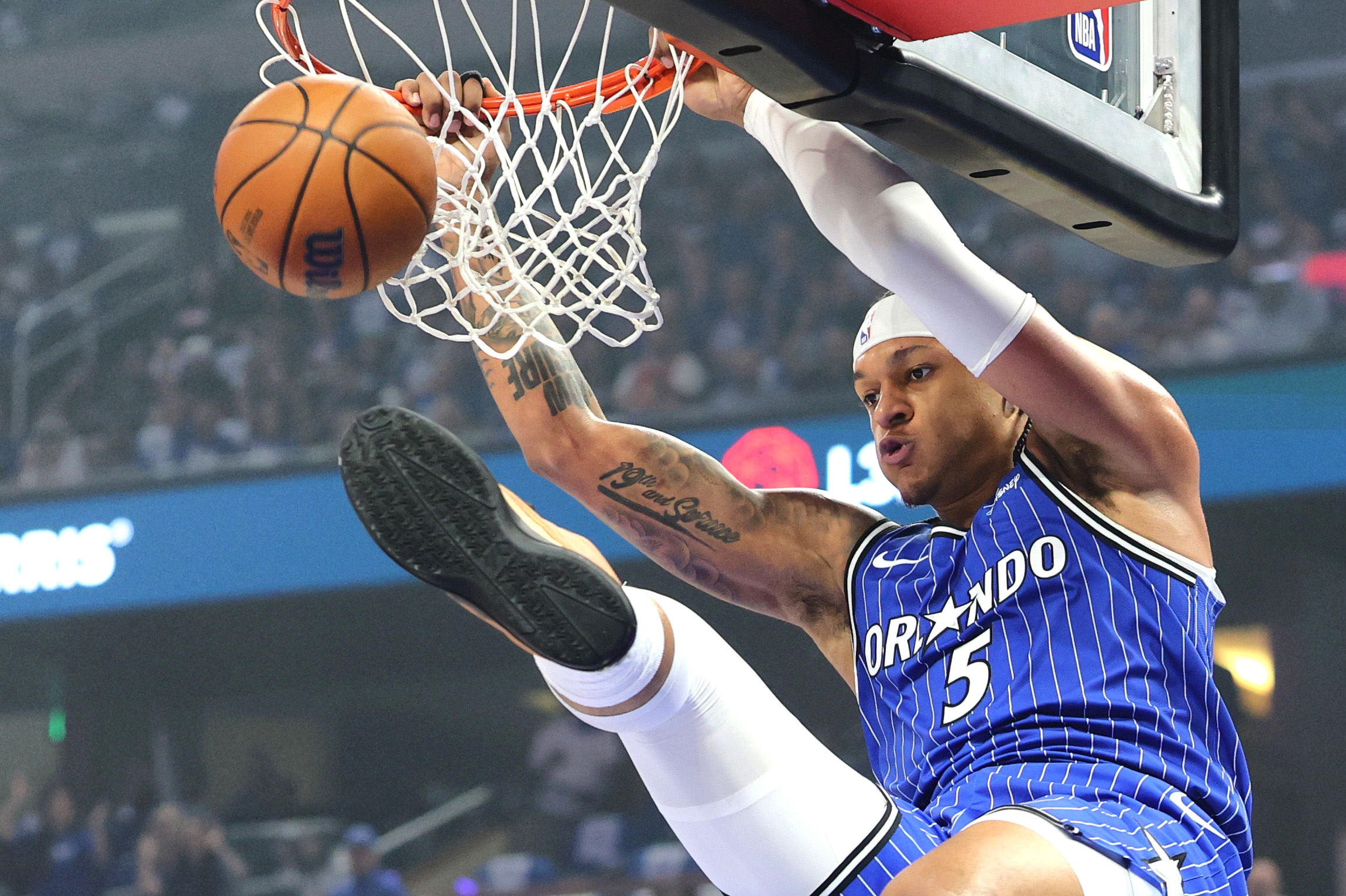 The Orlando Magic foward Paolo Banchero (#5) dunks against Detroit...