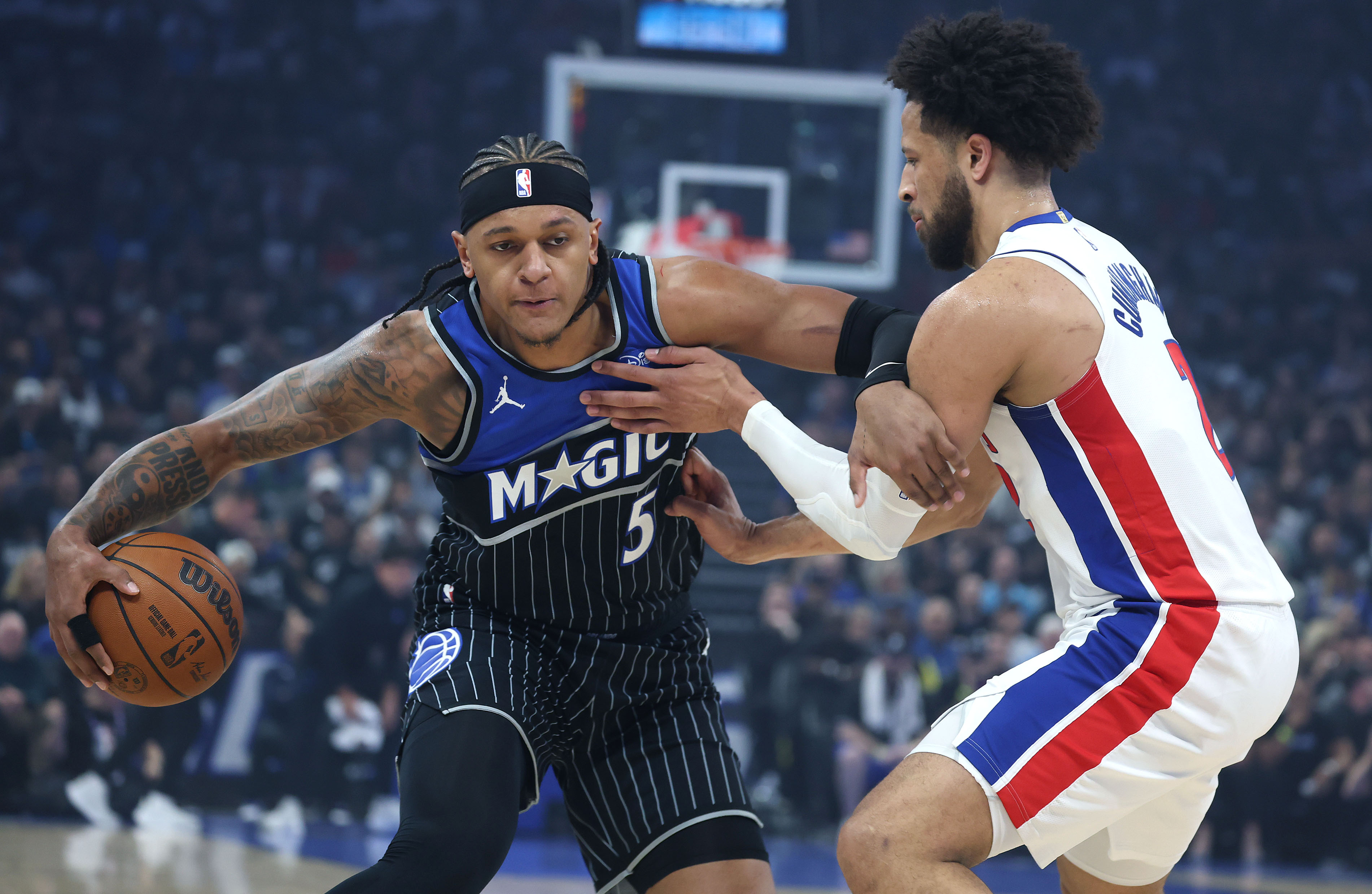Orlando forward Paolo Banchero (5) and Detroit guard Cade Cunningham...