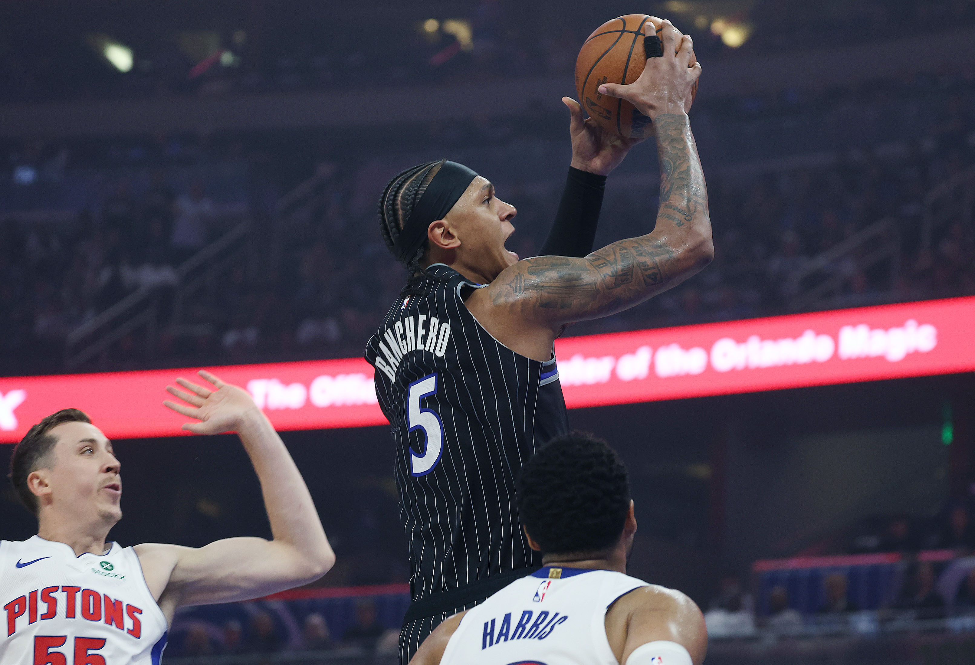 Orlando forward Paolo Banchero (5) soars over Detroit guard Duncan...