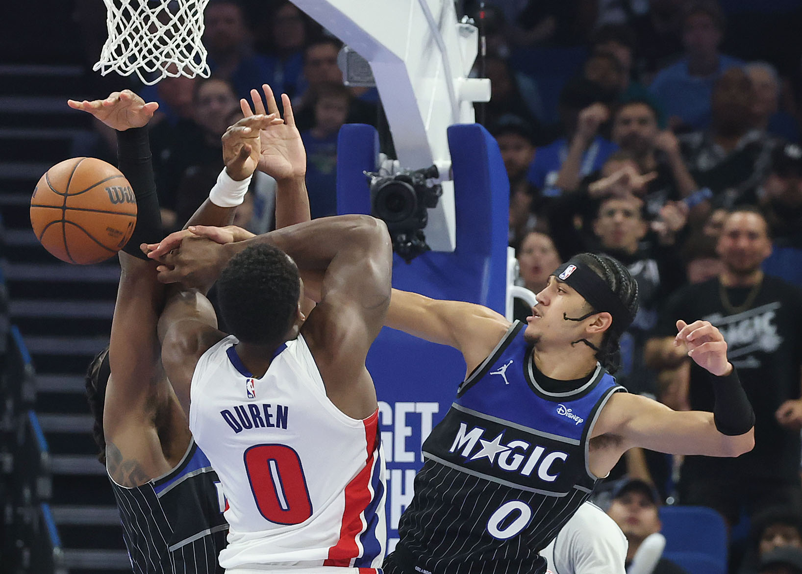 Orlando guard Anthony Black (right) stops a shot by Detroit...