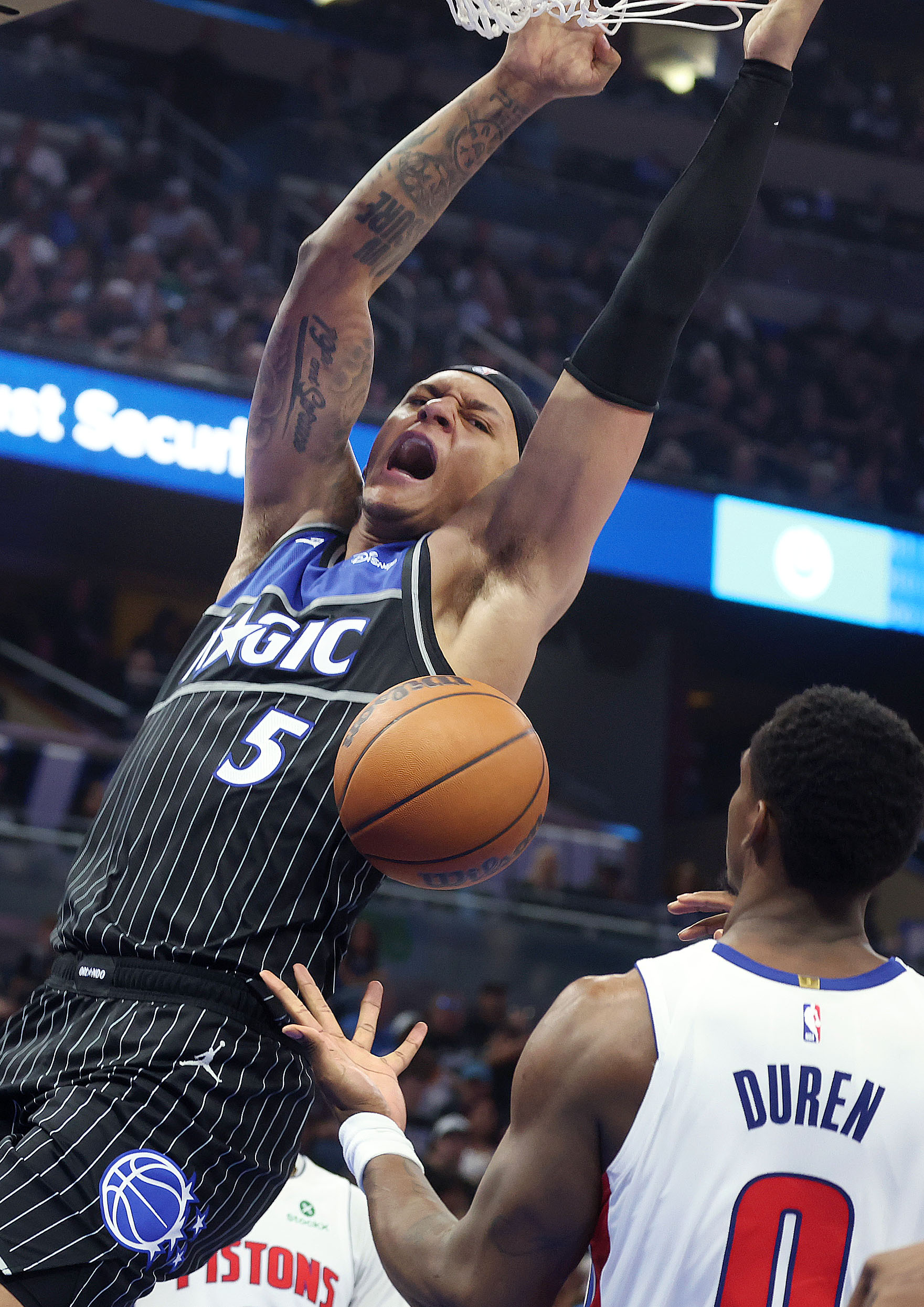 Orlando forward Paolo Banchero (5) slam dunks over Detroit center...