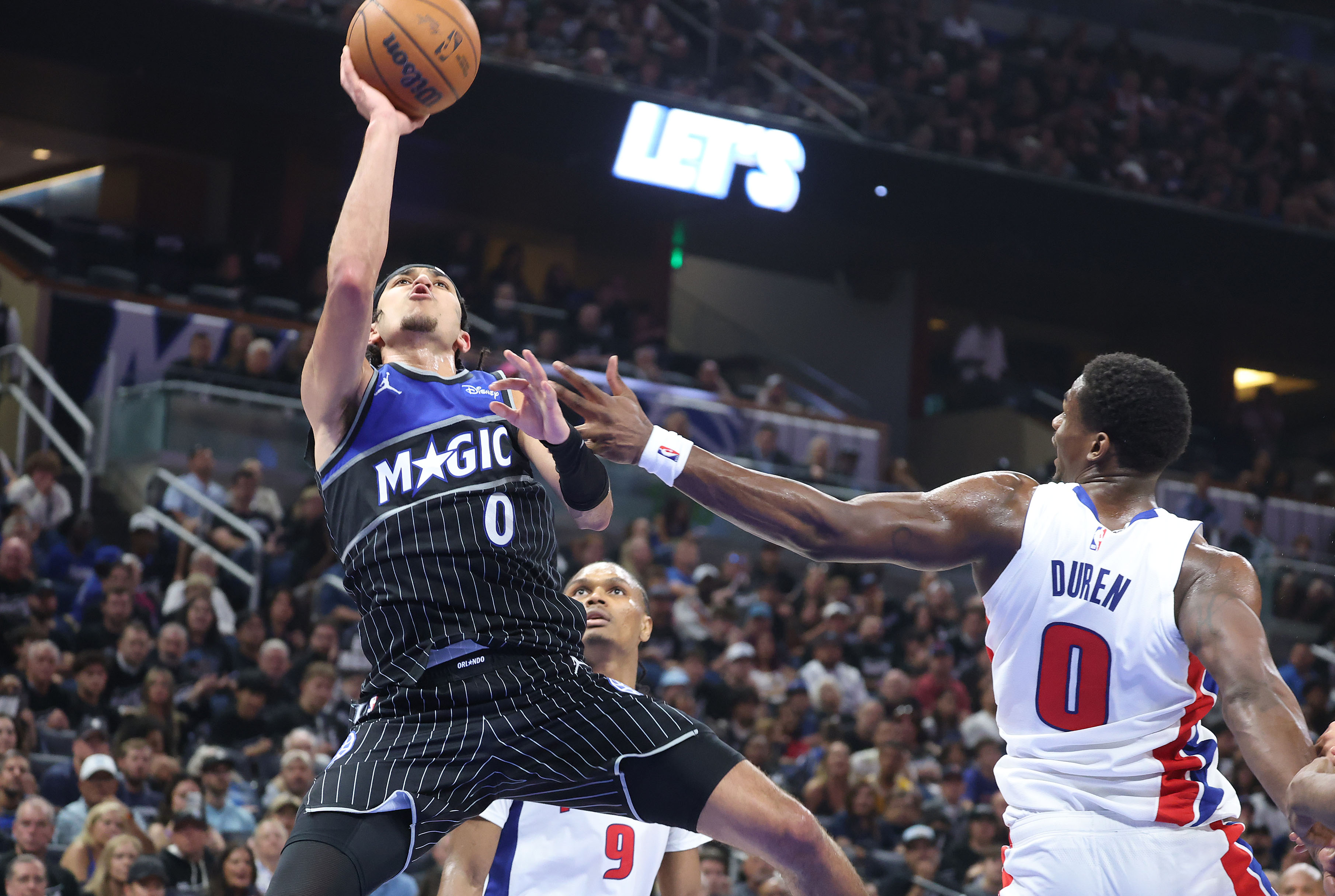 Orlando guard Anthony Black (0) shoots beside Detroit center Jalen...