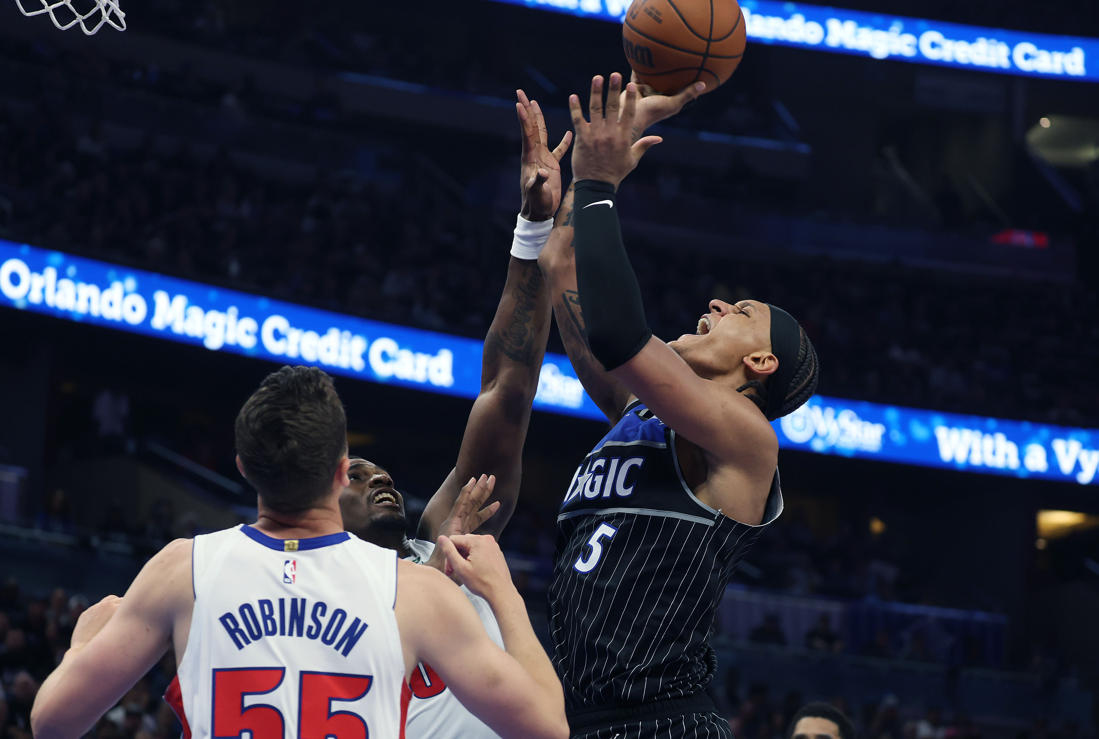 Orlando forward Paolo Banchero (5) scores over Detroit guard Duncan...