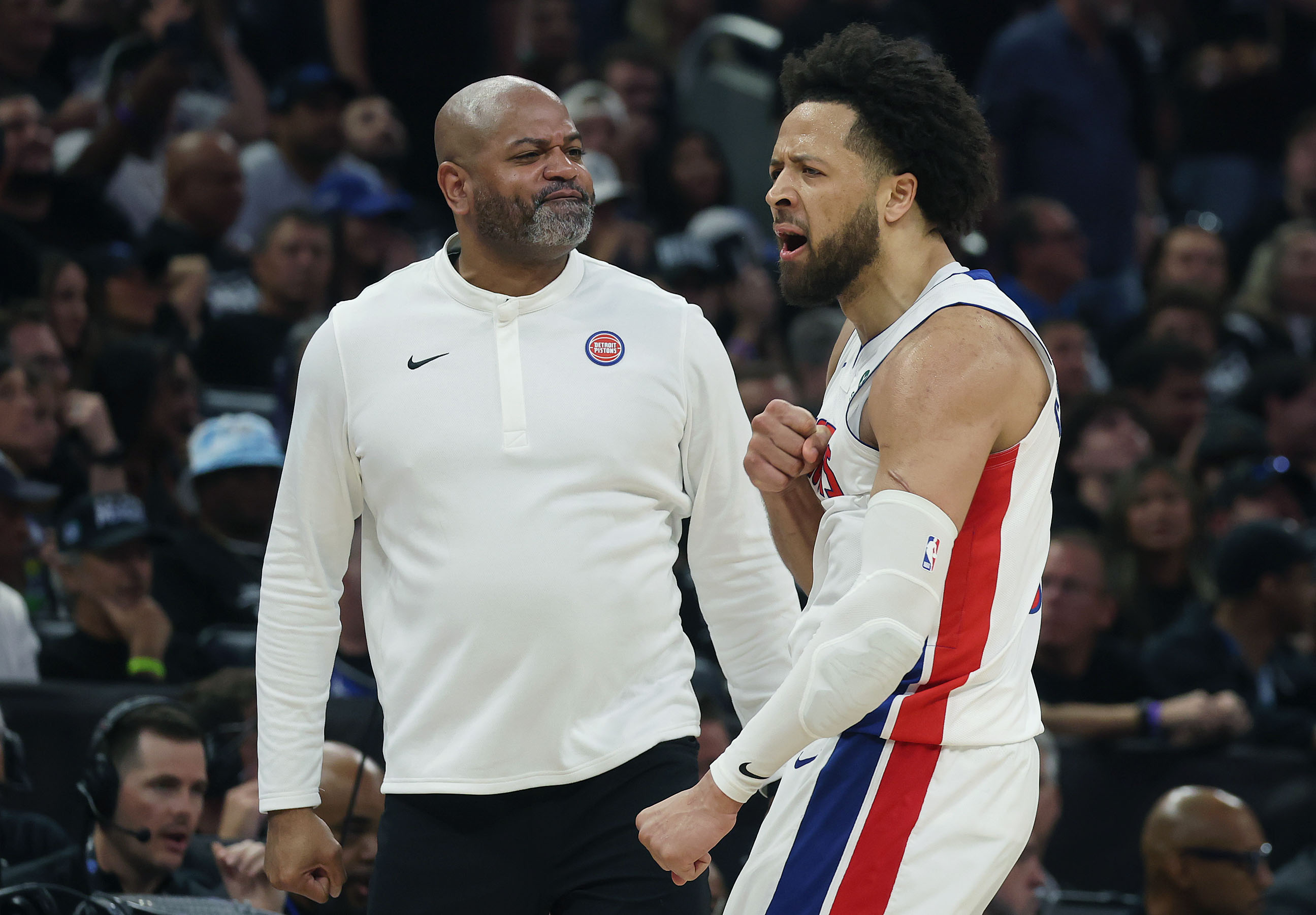 Detroit guard Cade Cunningham celebrates with head coach JB Bickerstaff...