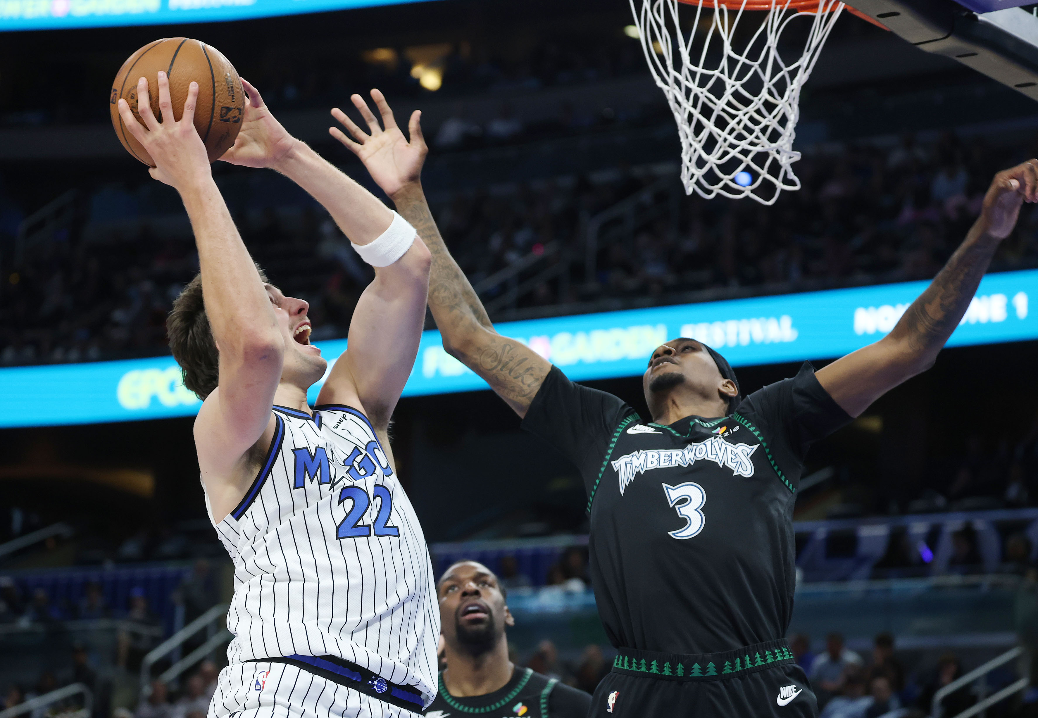 Orlando forward Franz Wagner (22) scores past Minnesota forward Jaden...