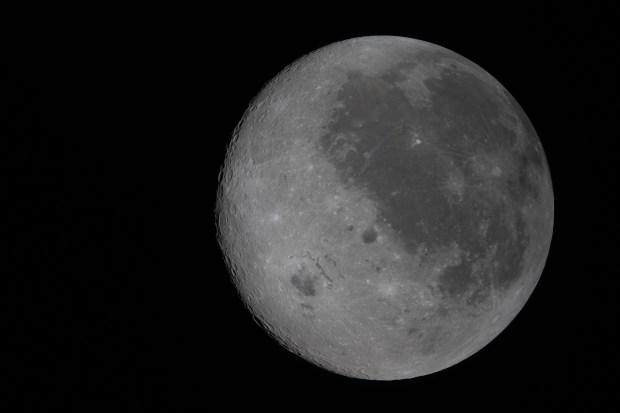 In this fully illuminated view of the moon from April 6, 2026 taken from Orion on the Artemis II mission, the near side (the hemisphere seen from Earth), is visible on the right. It is identifiable by the dark splotches that cover its surface. These are ancient lava flows from a time early in the moon's history when it was volcanically active. The large crater west of the lava flows is Orientale basin, a nearly 600-mile-wide crater that straddles the moon's near and far sides. Orientale's left half is not visible from Earth, but in this image is full view of the crater. Everything to the left of the crater is the far side, the hemisphere not seen from Earth because the moon rotates on its axis at the same rate that it orbits round us. (Courtesy/NASA)