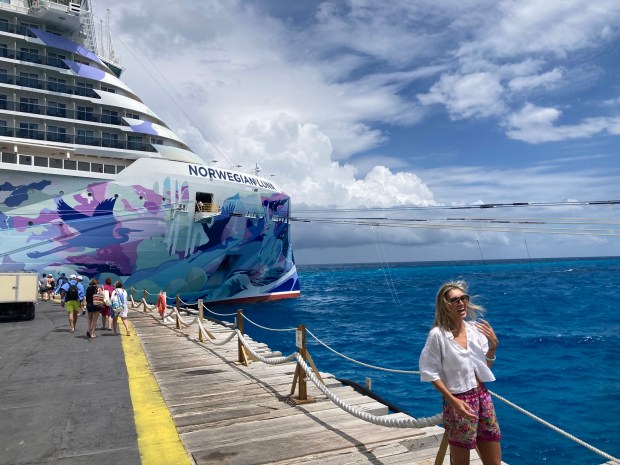 The Norwegian Luna godmother and hull artist ELLE, who came to fame as a New York graffiti artist, poses on the dock at Norwegian Cruise Line's private Bahamas island Great Stirrup Cay on March 29, 2026. (Richard Tribou/Orlando Sentinel)