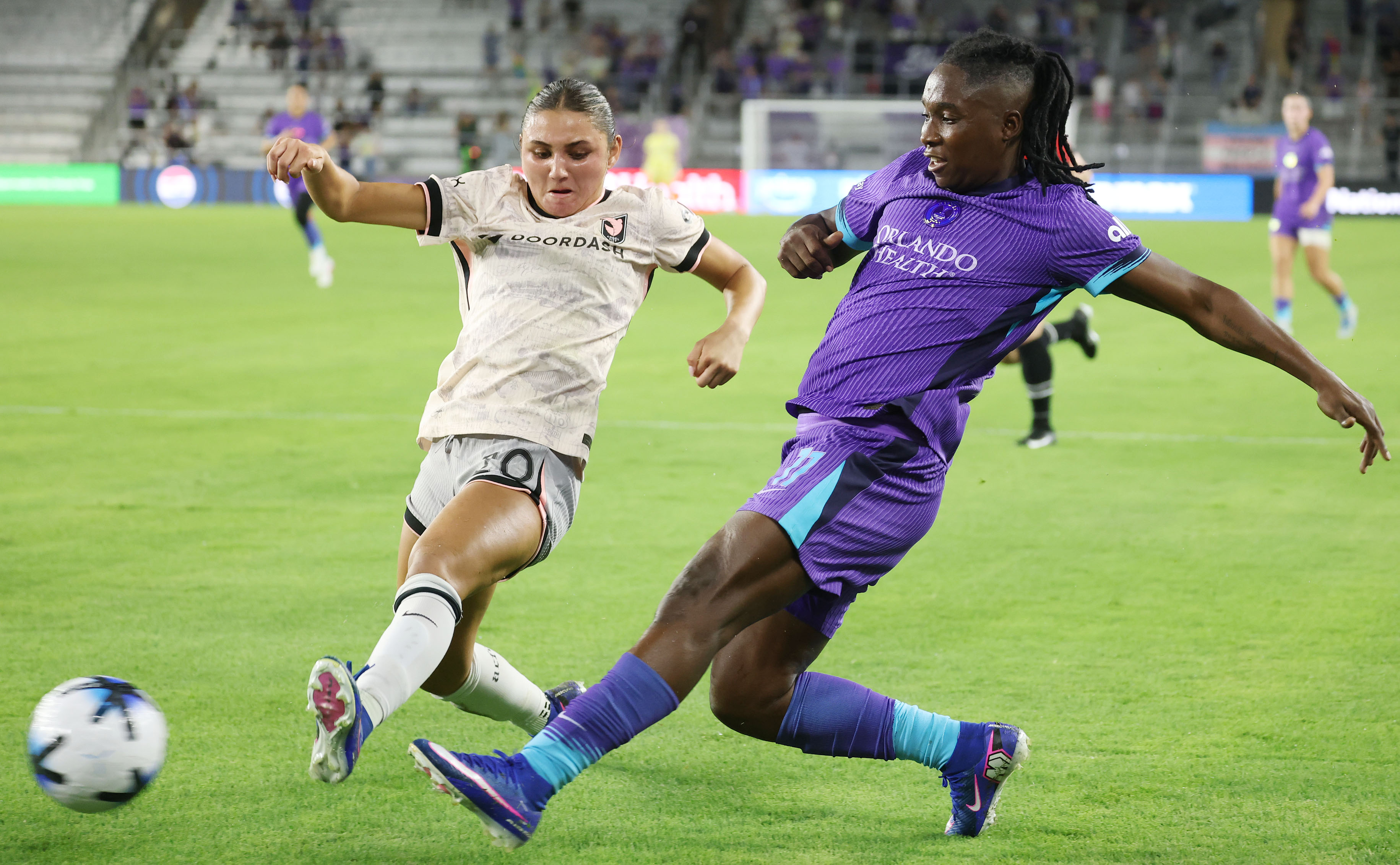 Pride player Barbra Banda (11) kicks past Angel City player...