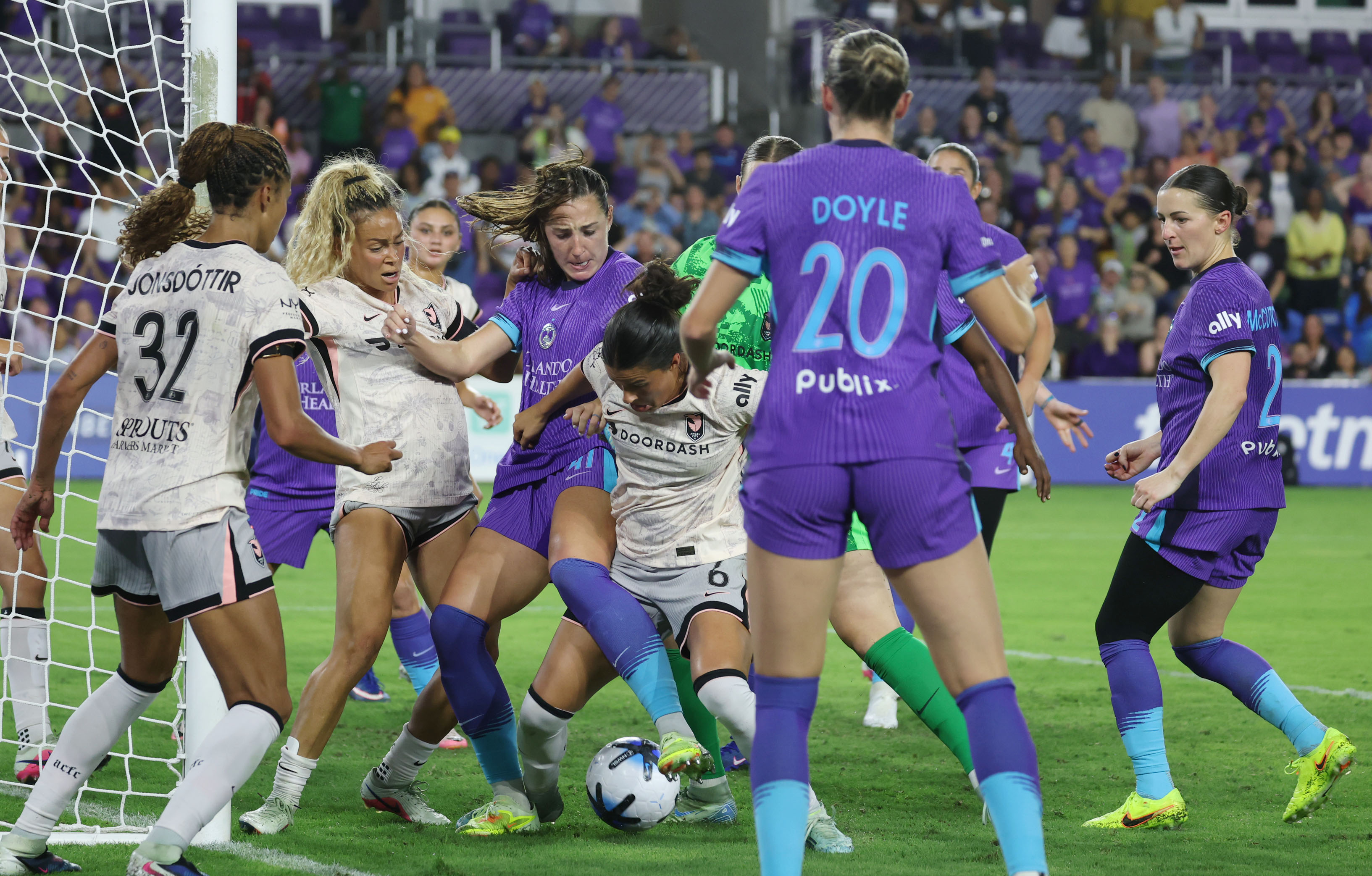 Pride players scrum with Angel City players in front of...