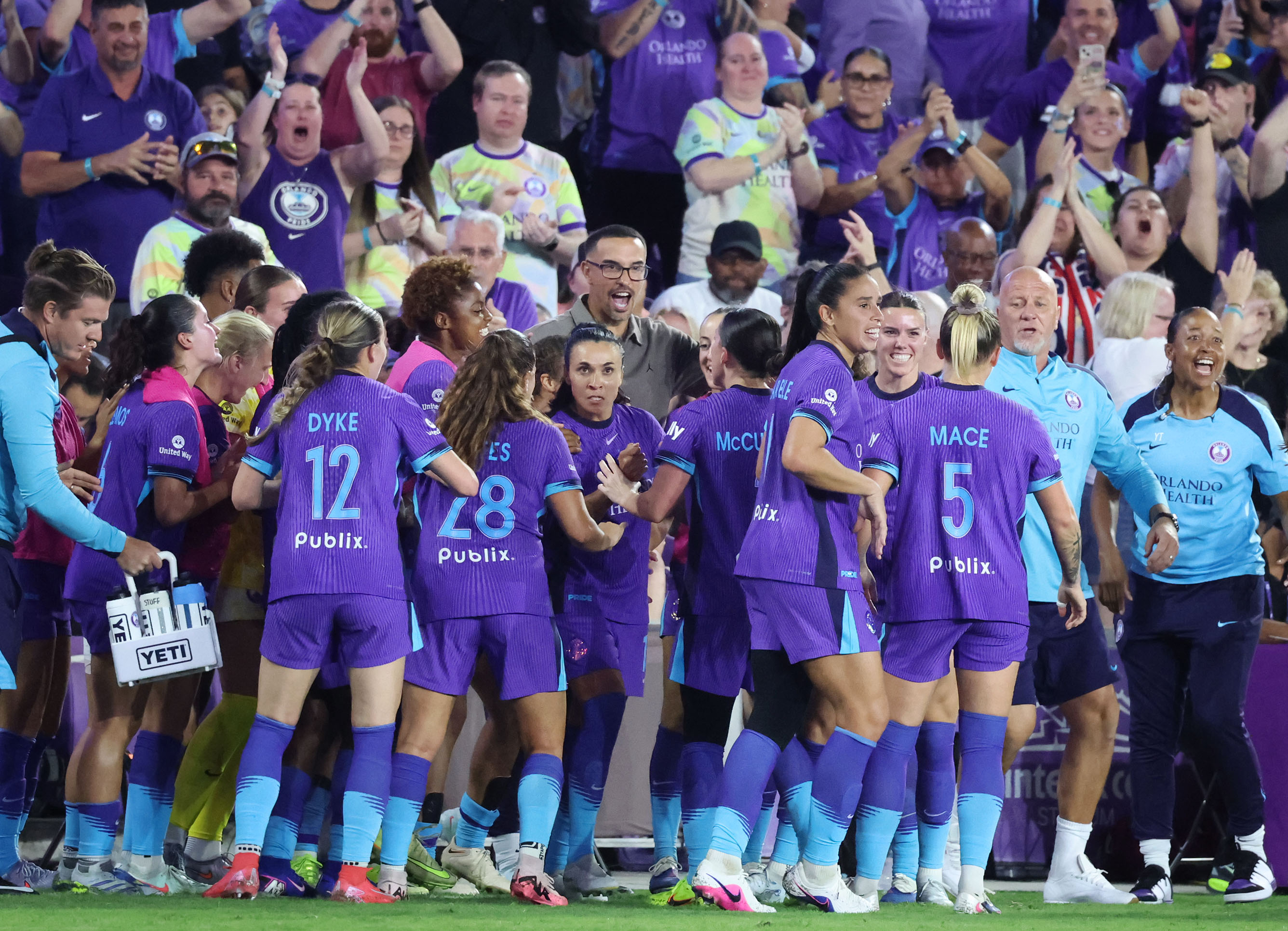 Pride players and head coach Seb Hines celebrate after a...