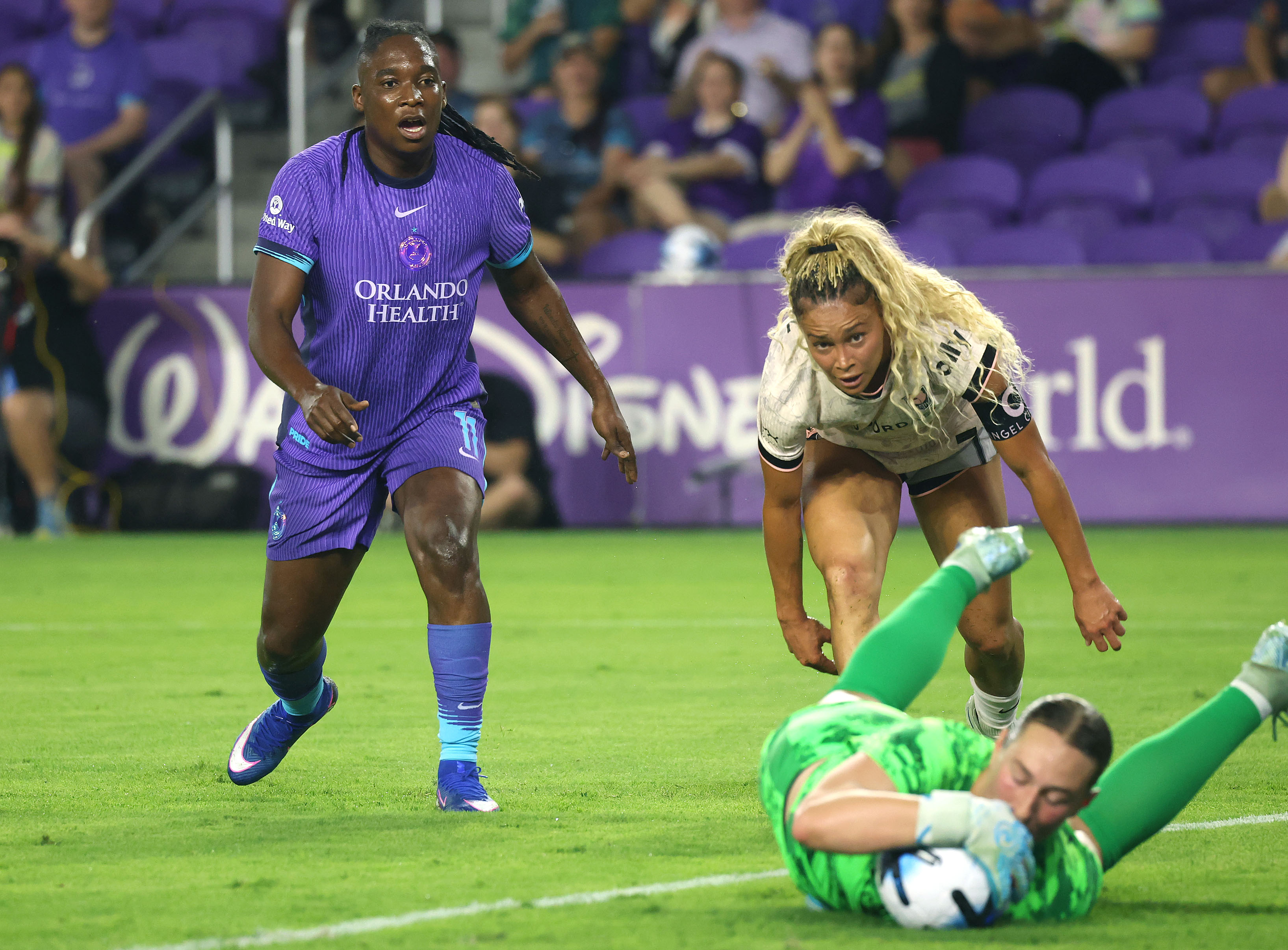 Pride player Barbra Banda (left) watches Angel City goalkeeper Angelina...