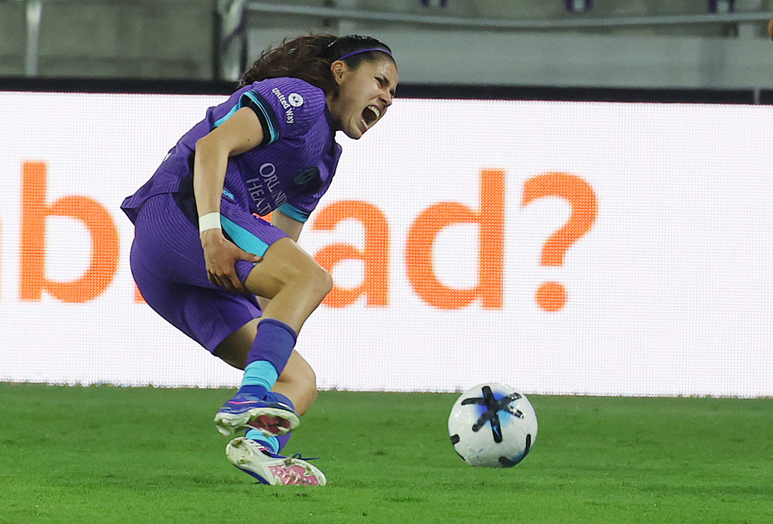 Pride player Jacqueline Ovalle grabs her leg as she falls...