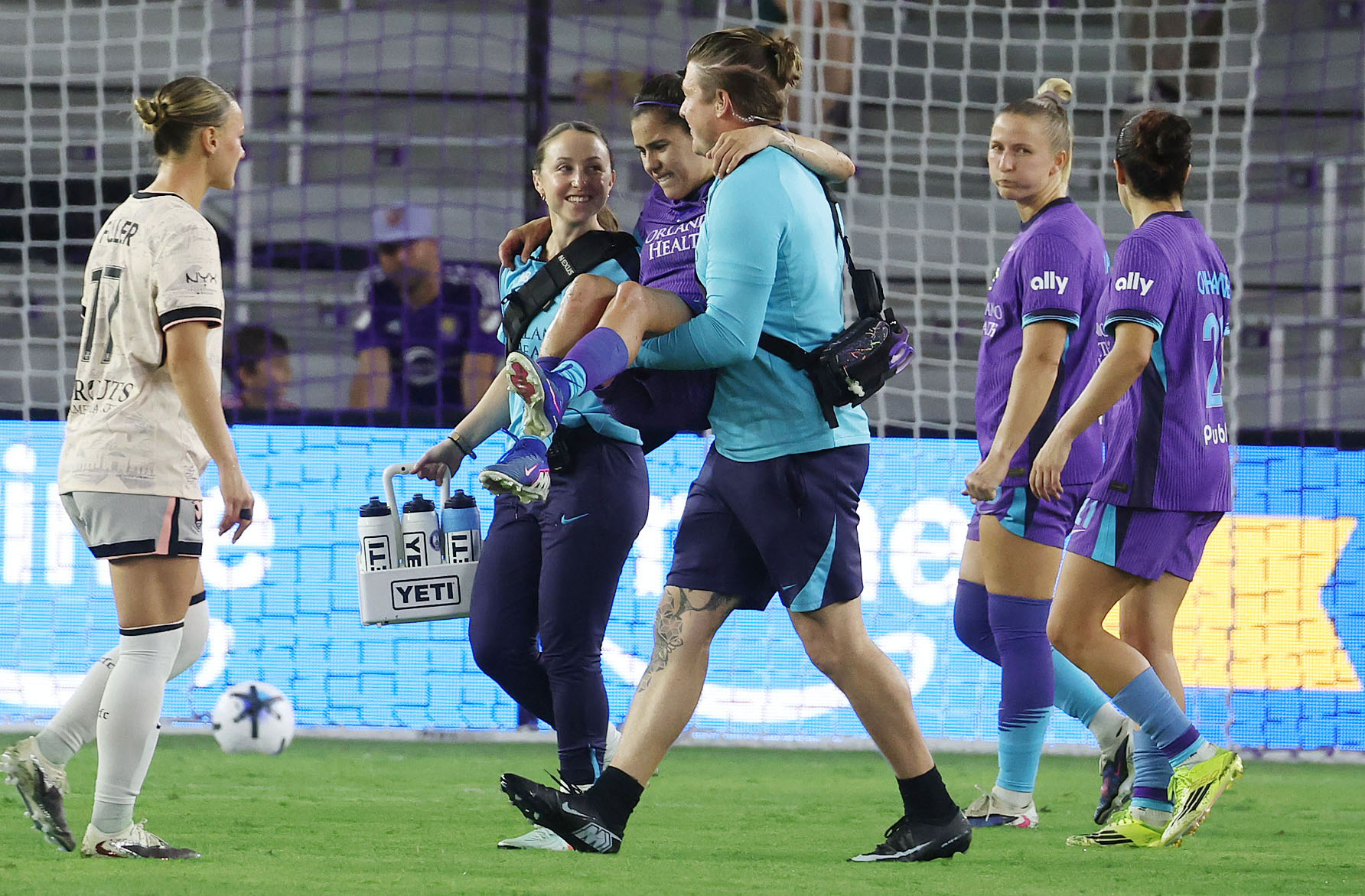 Pride player Jacqueline Ovalle is carried off the pitch after...