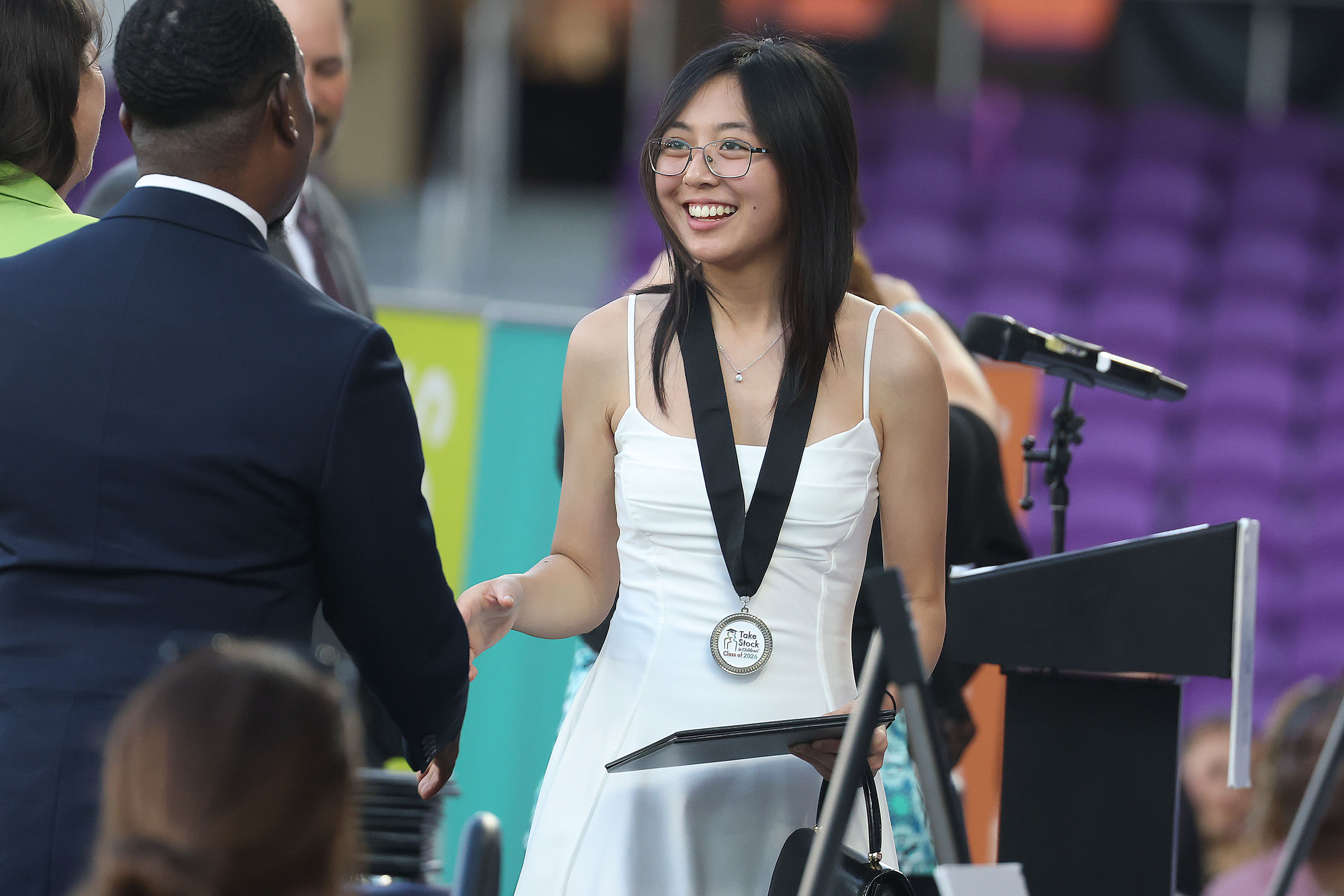 Graduate Alexis Vu gets her diploma during the Take Stock...