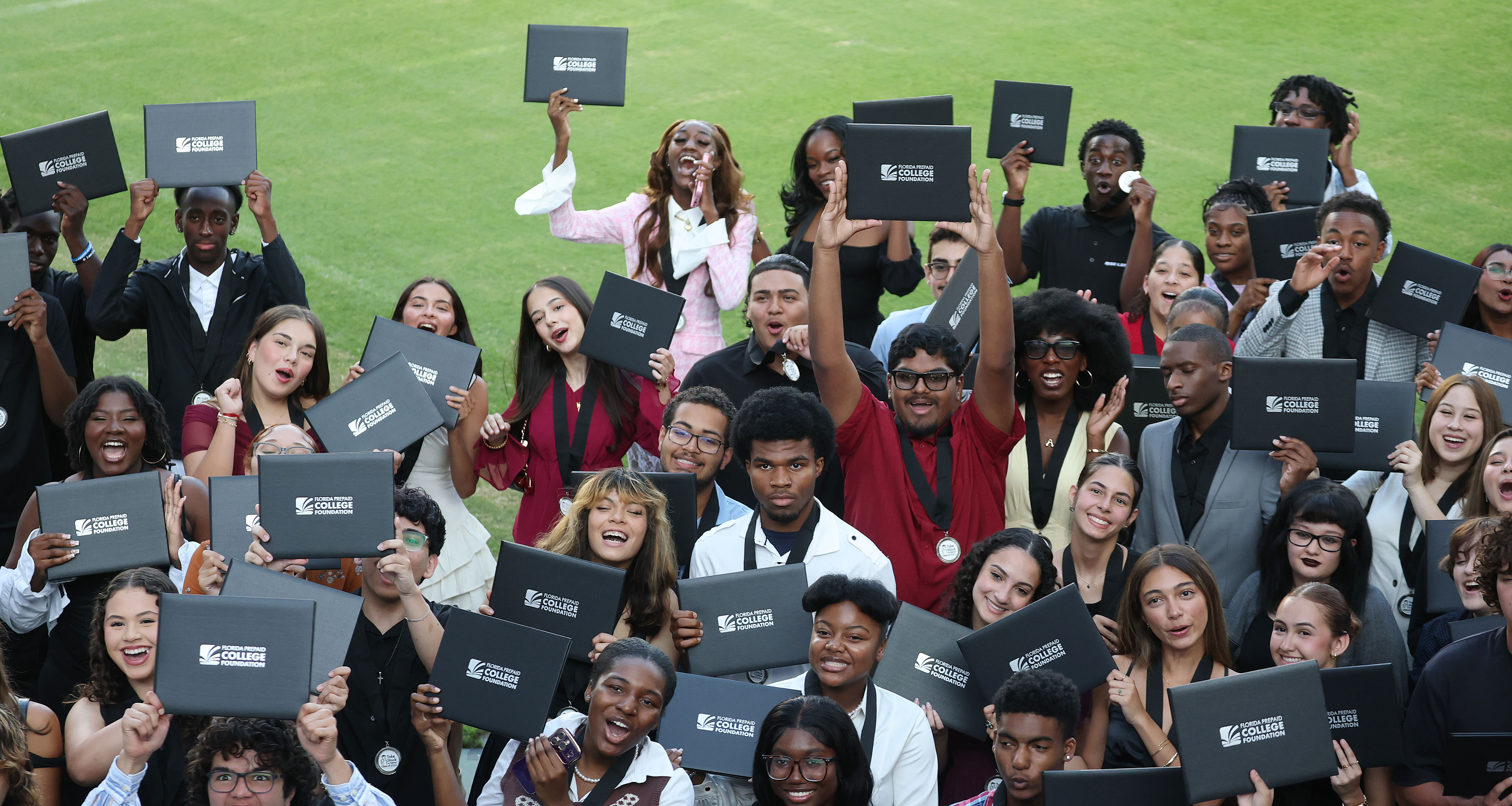 Graduates pose for a group photo during the Take Stock...