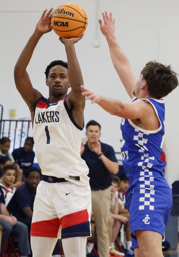 Brandon Bass Jr. (1) shoots as Windermere Prep coach Brian Hoff (center) watches from the sideline. Bass is one of six Orlando area players who surpassed 2,500 career points in high school. (Stephen M. Dowell/Orlando Sentinel)