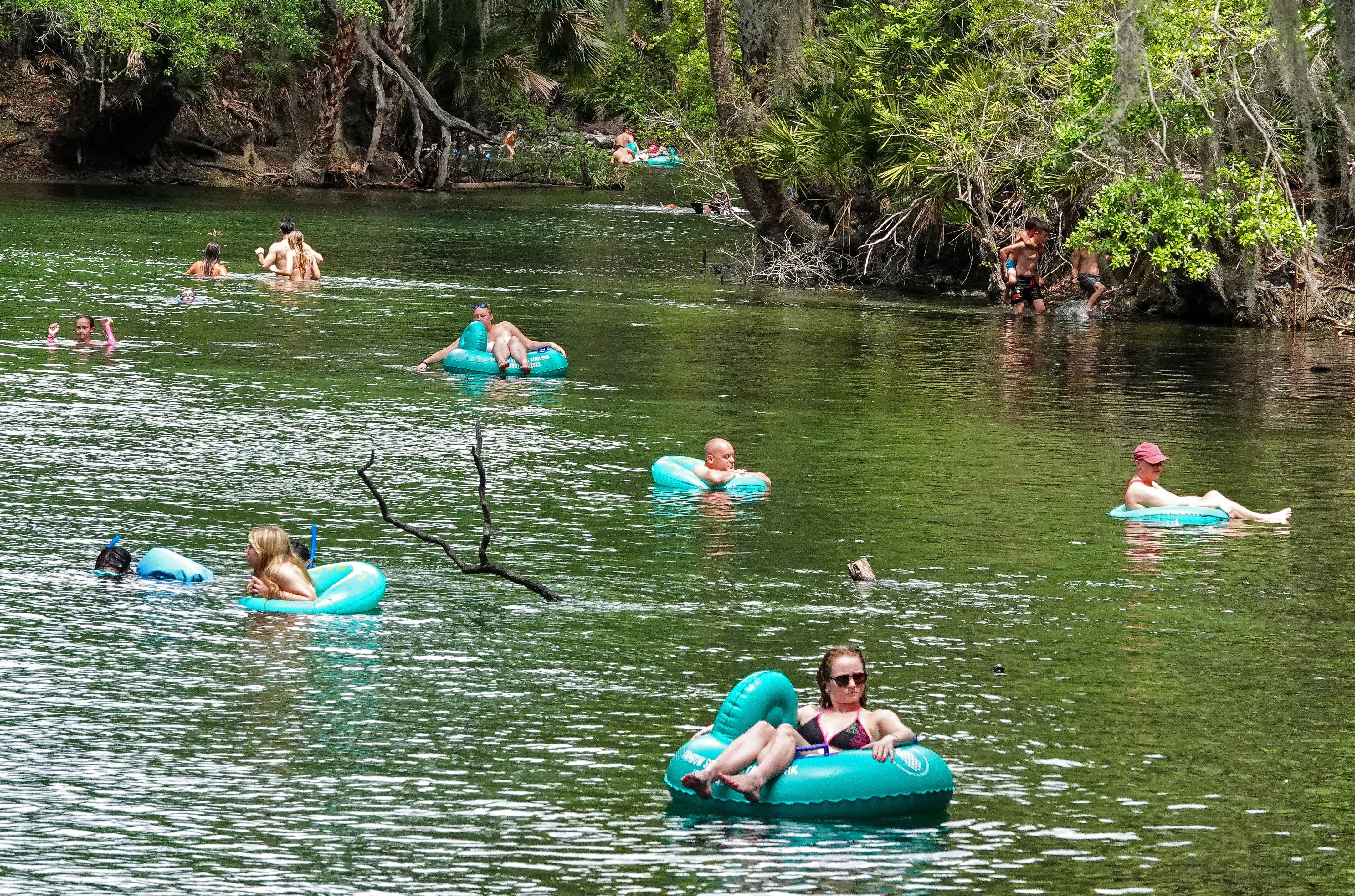 ENJOYING THE BLUE â Tubers float down the run at...